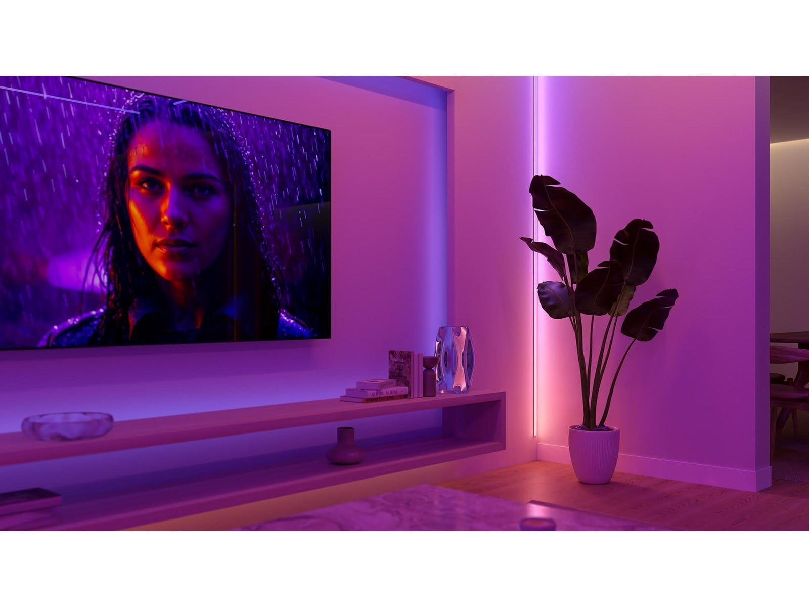 Donna sotto la pioggia sullo schermo, luce viola, pianta in vaso, mensola.