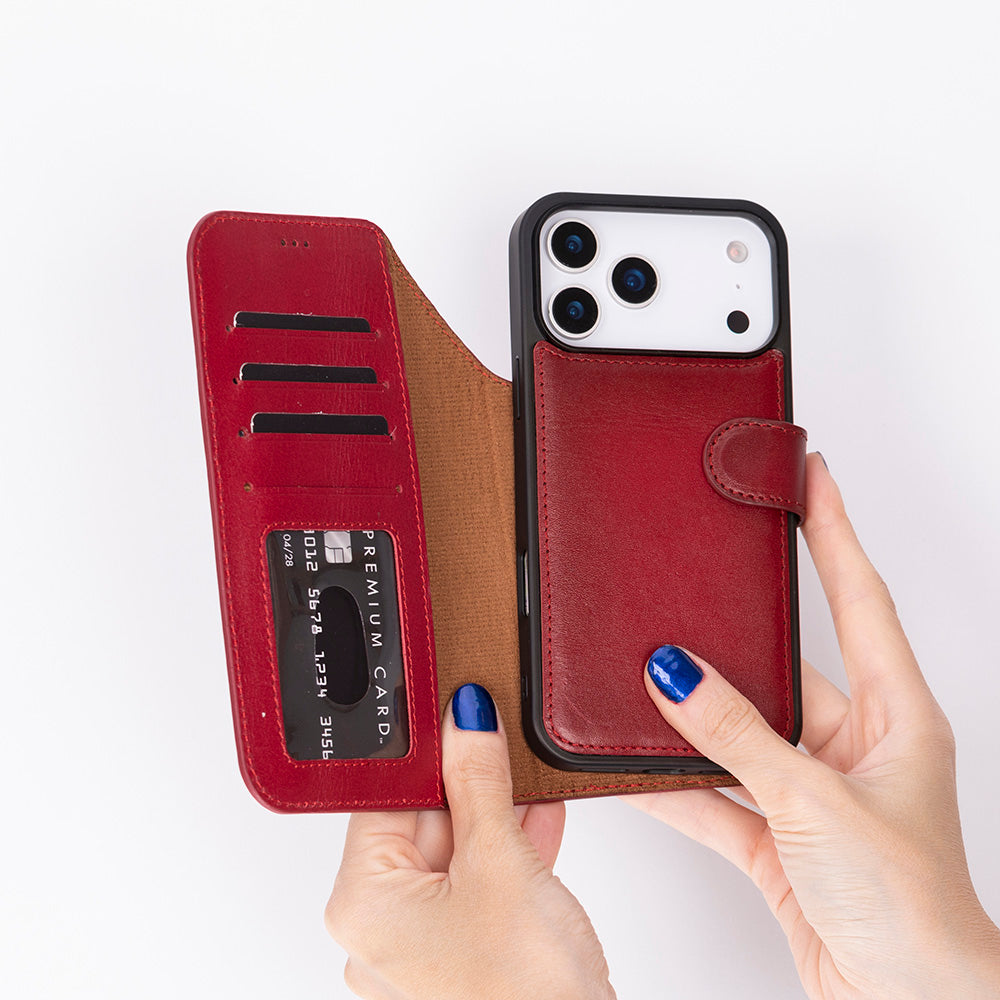 Eller, içinde kredi kartı olan kırmızı deri telefon kılıfını açık tutuyor. Beyaz arka plan.