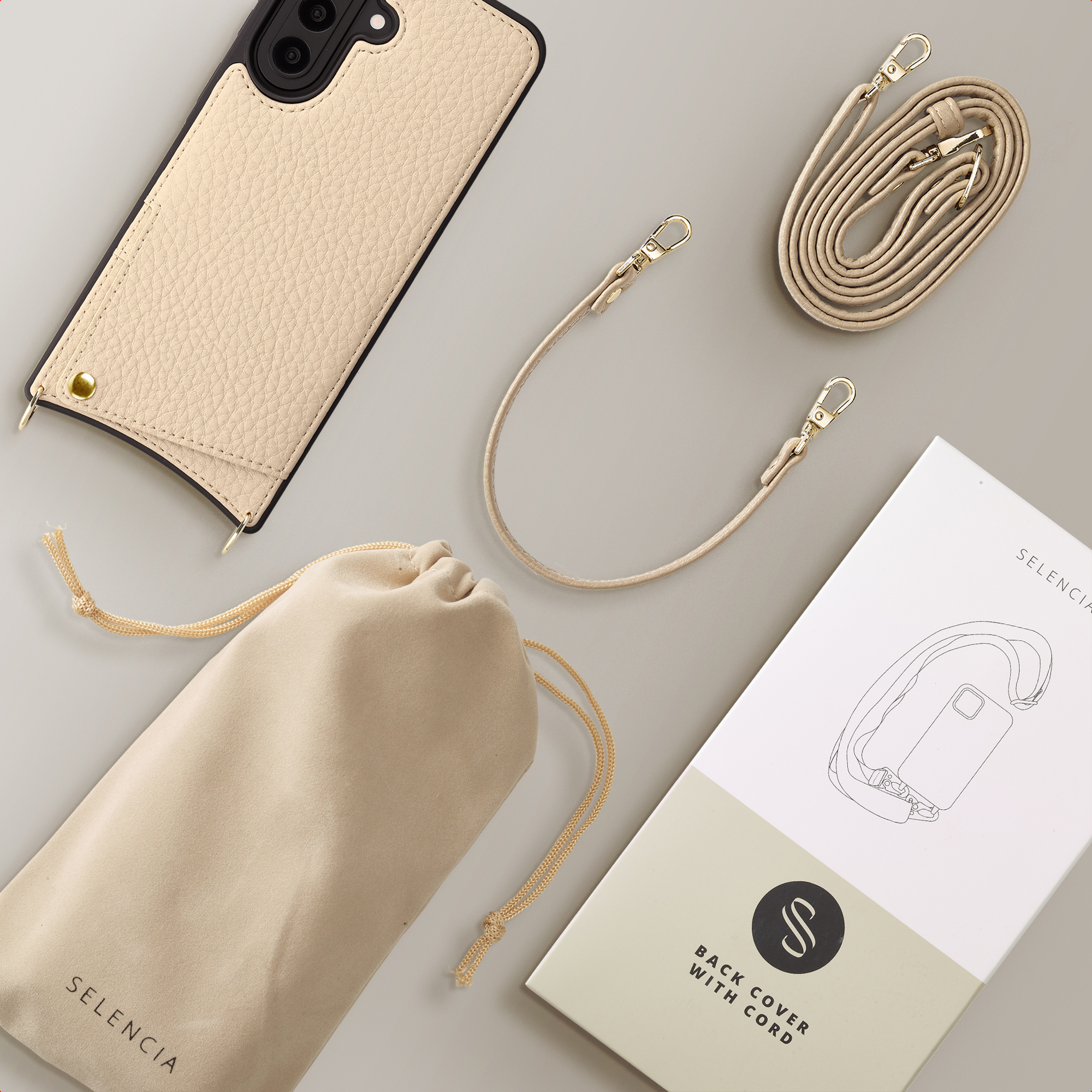 Une coque de téléphone couleur crème avec une lanière amovible et une pochette.