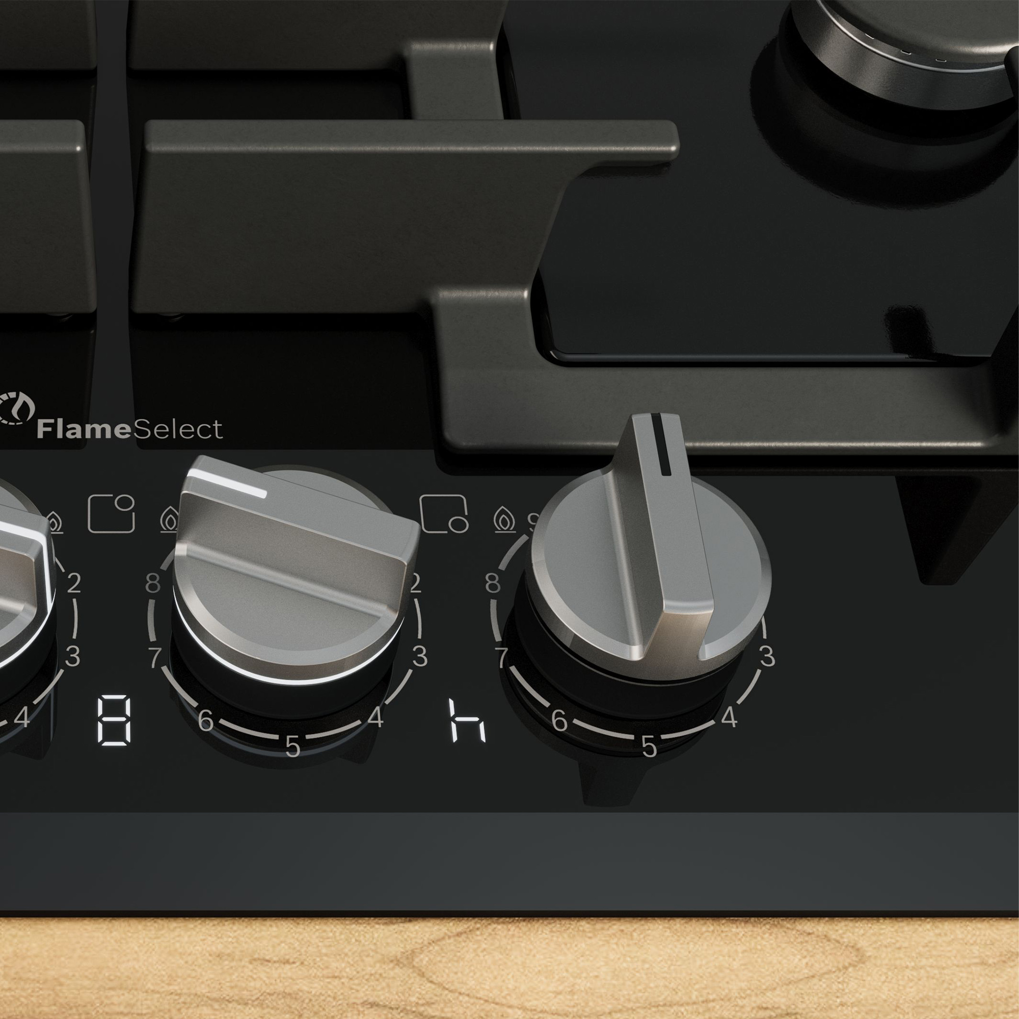 Kuchenka gazowa z dwoma pokrętłami i wyświetlaczem cyfrowym. Pokrętła są srebrne i działają.