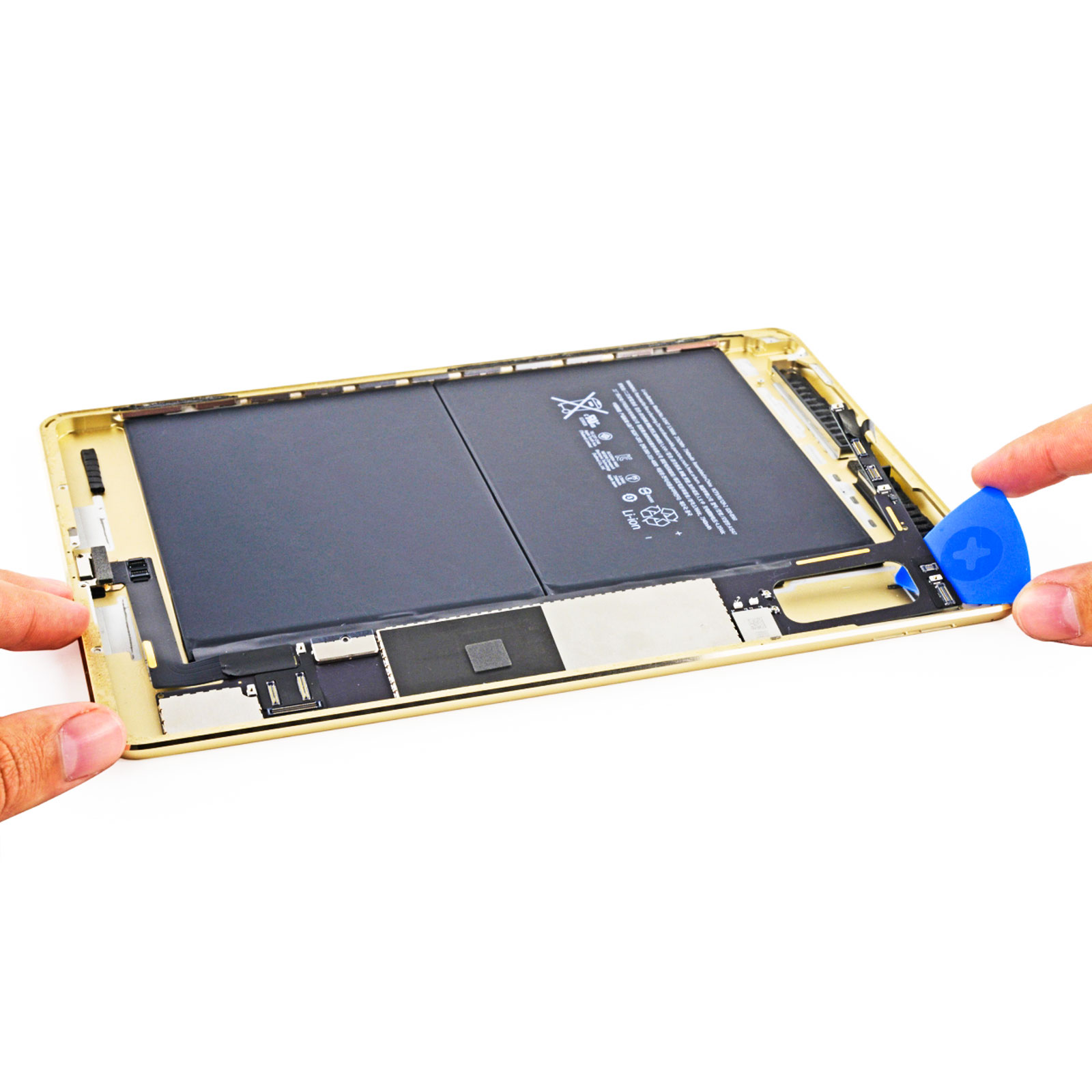 Un tablet dorato con la batteria esposta, in riparazione.