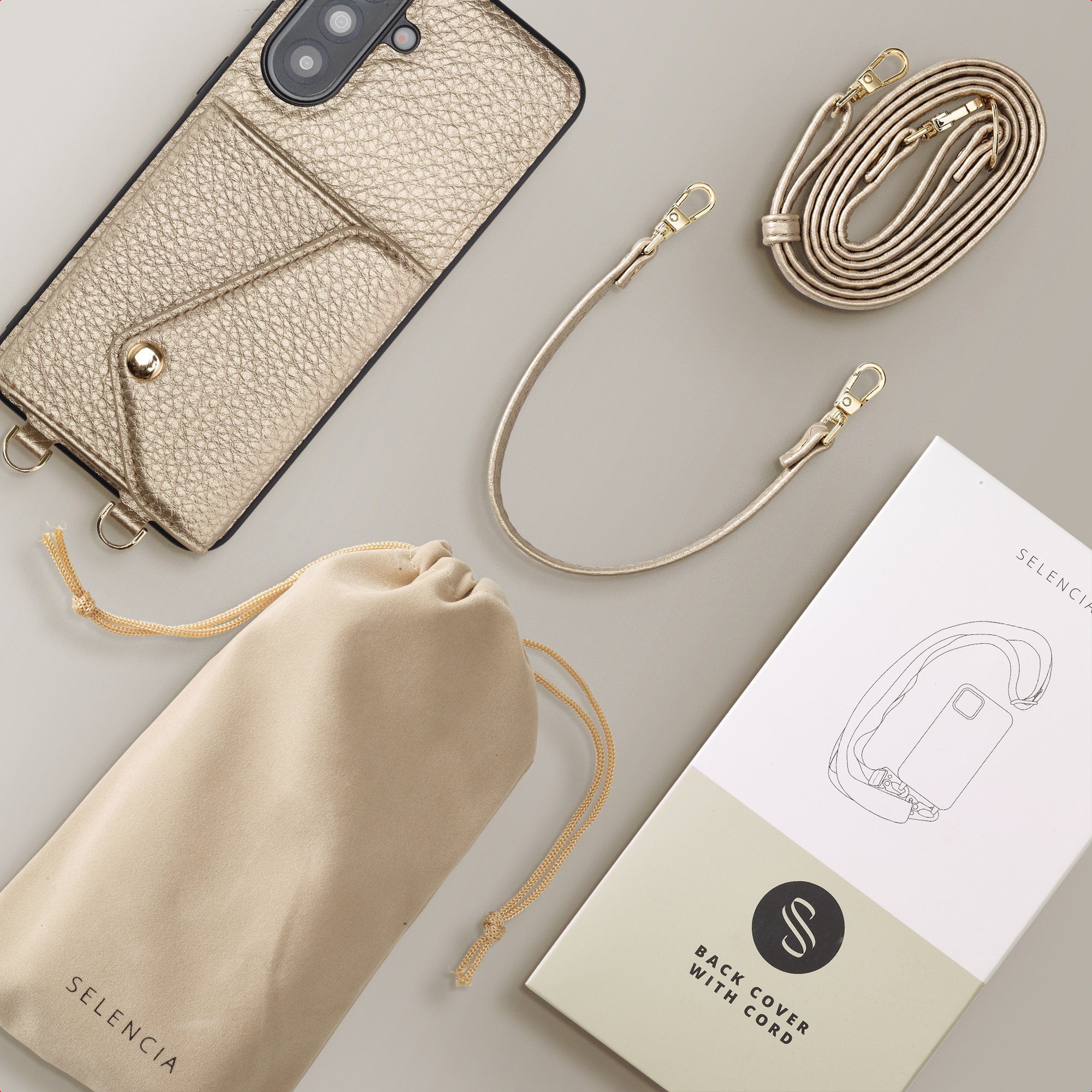 Gouden telefoonhoes met vakje, koord, buidel en productdoos.