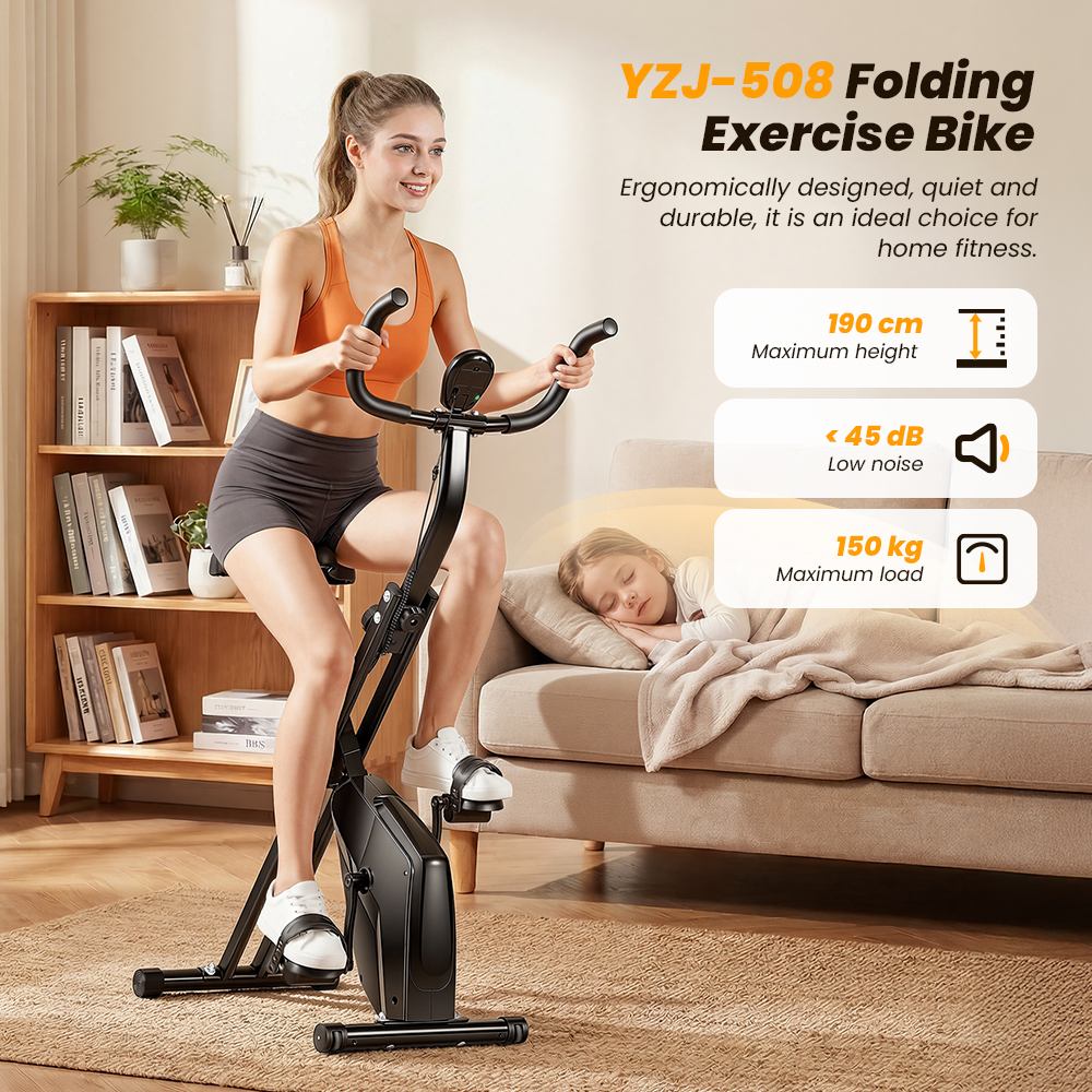 Kobieta ćwiczy na czarnym składanym rowerku stacjonarnym, podczas gdy dziecko śpi obok.