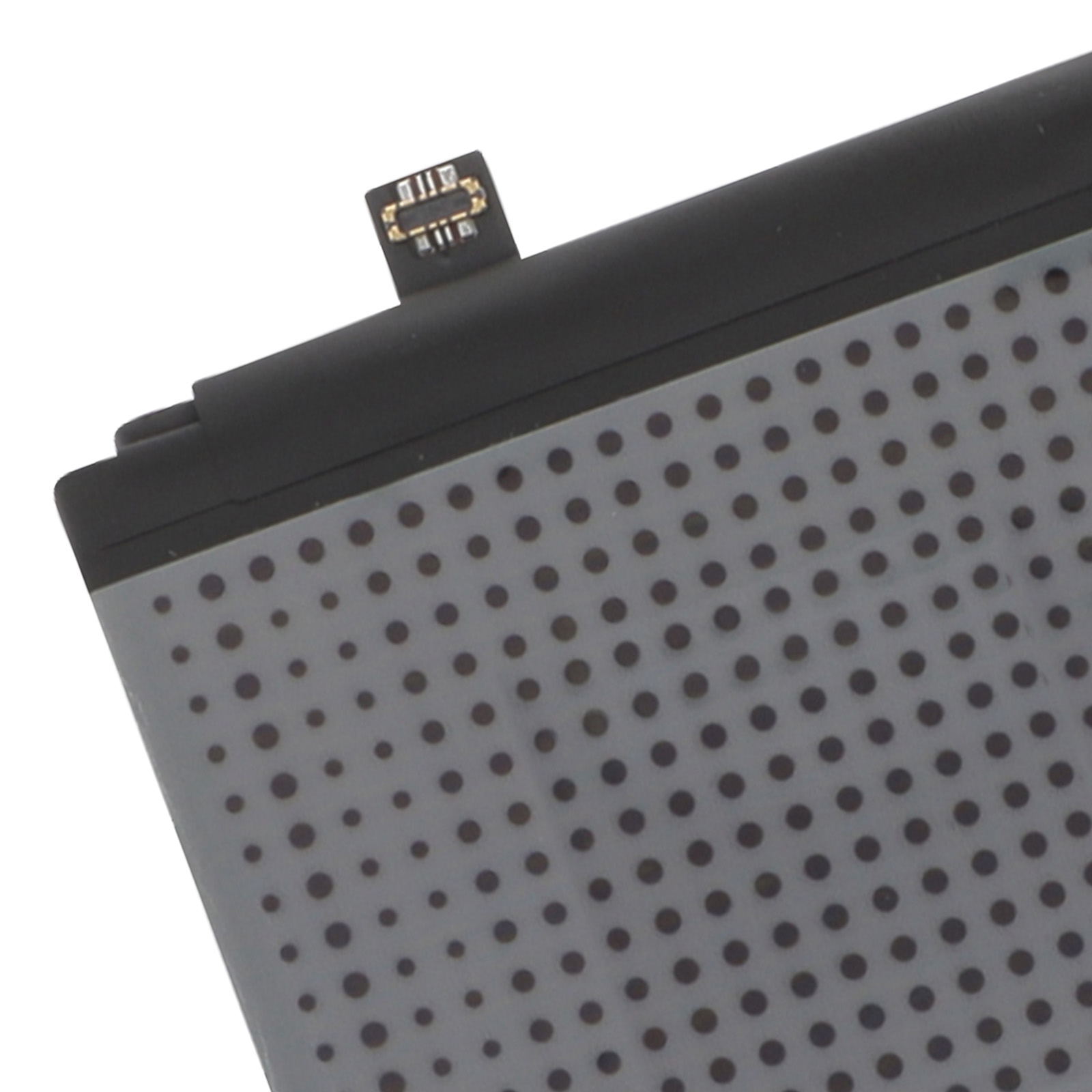 Batteria grigia con punti neri e piccolo connettore.