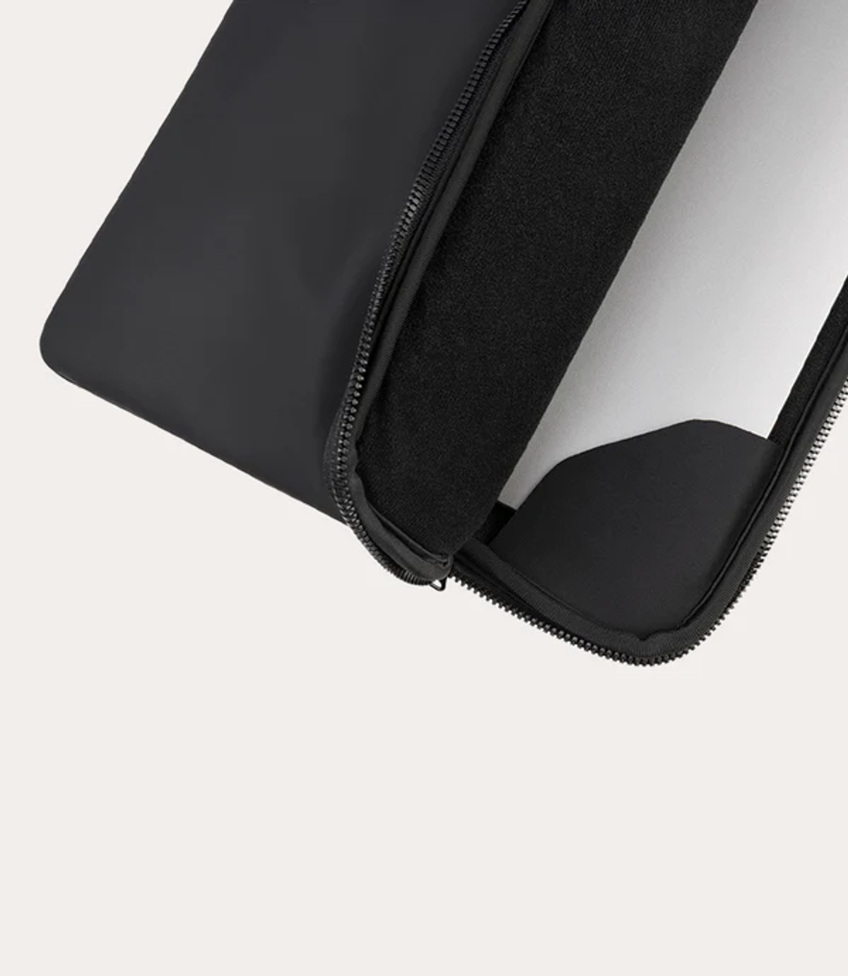 A black laptop sleeve with a zipper partially open, revealing a soft lining.