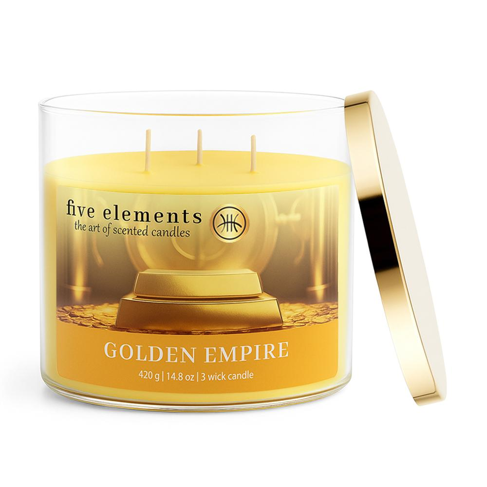 Ein gelbes 3-Docht-Glas mit goldener Kappe, das eine Kerze namens Golden Empire enthält.