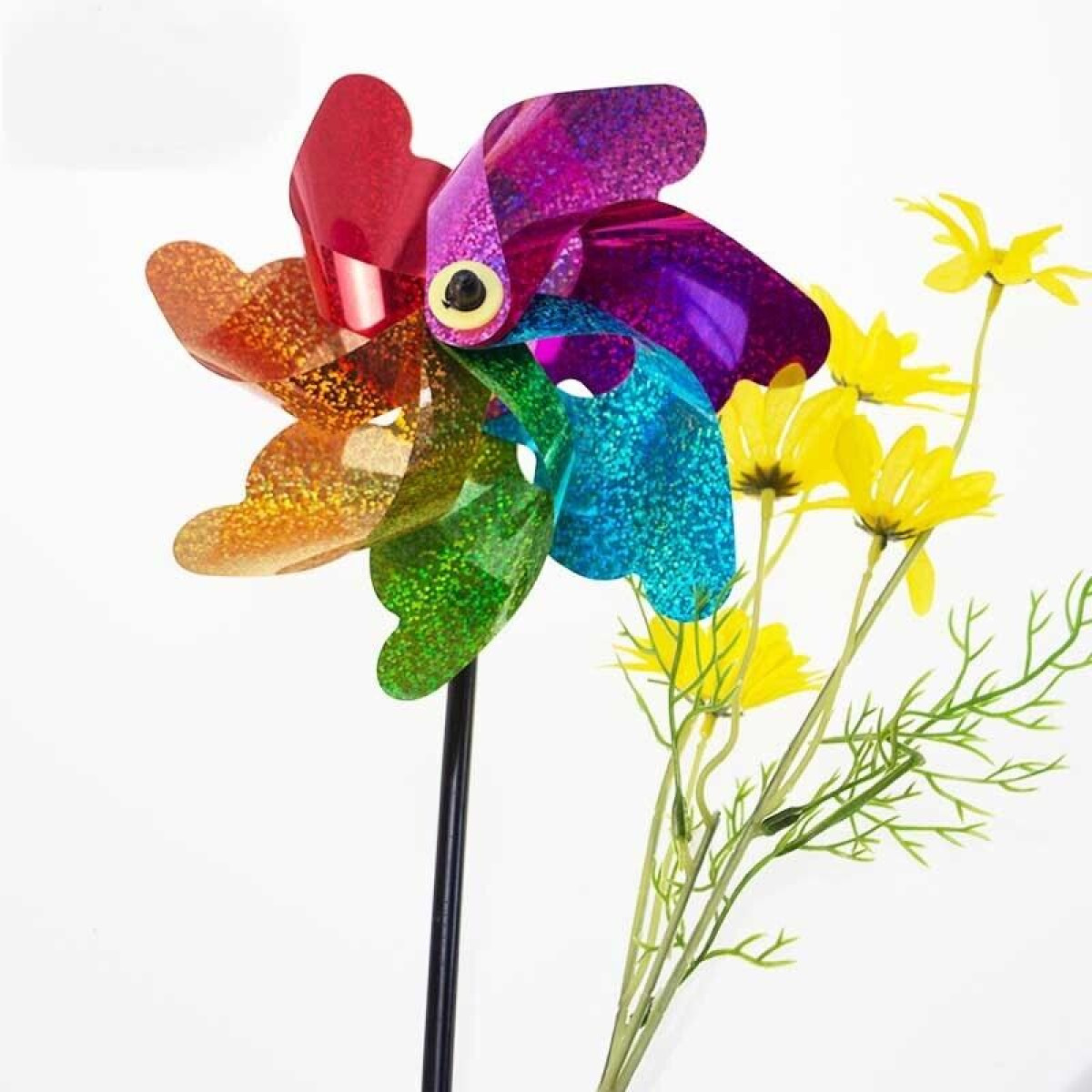 A colorful pinwheel with yellow flowers against a white background.