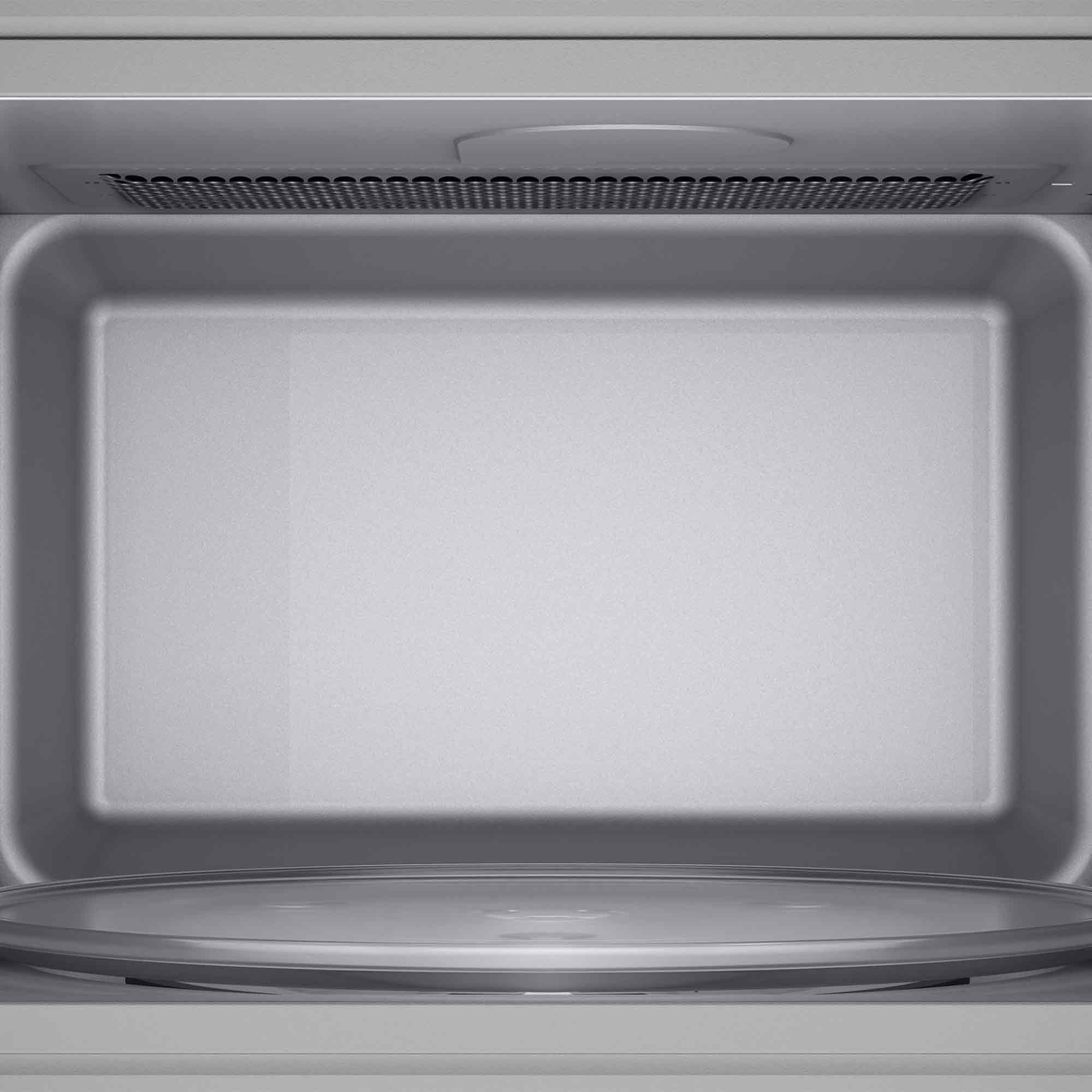 Wnętrze srebrnej kuchenki mikrofalowej ze szklanym talerzem obrotowym.