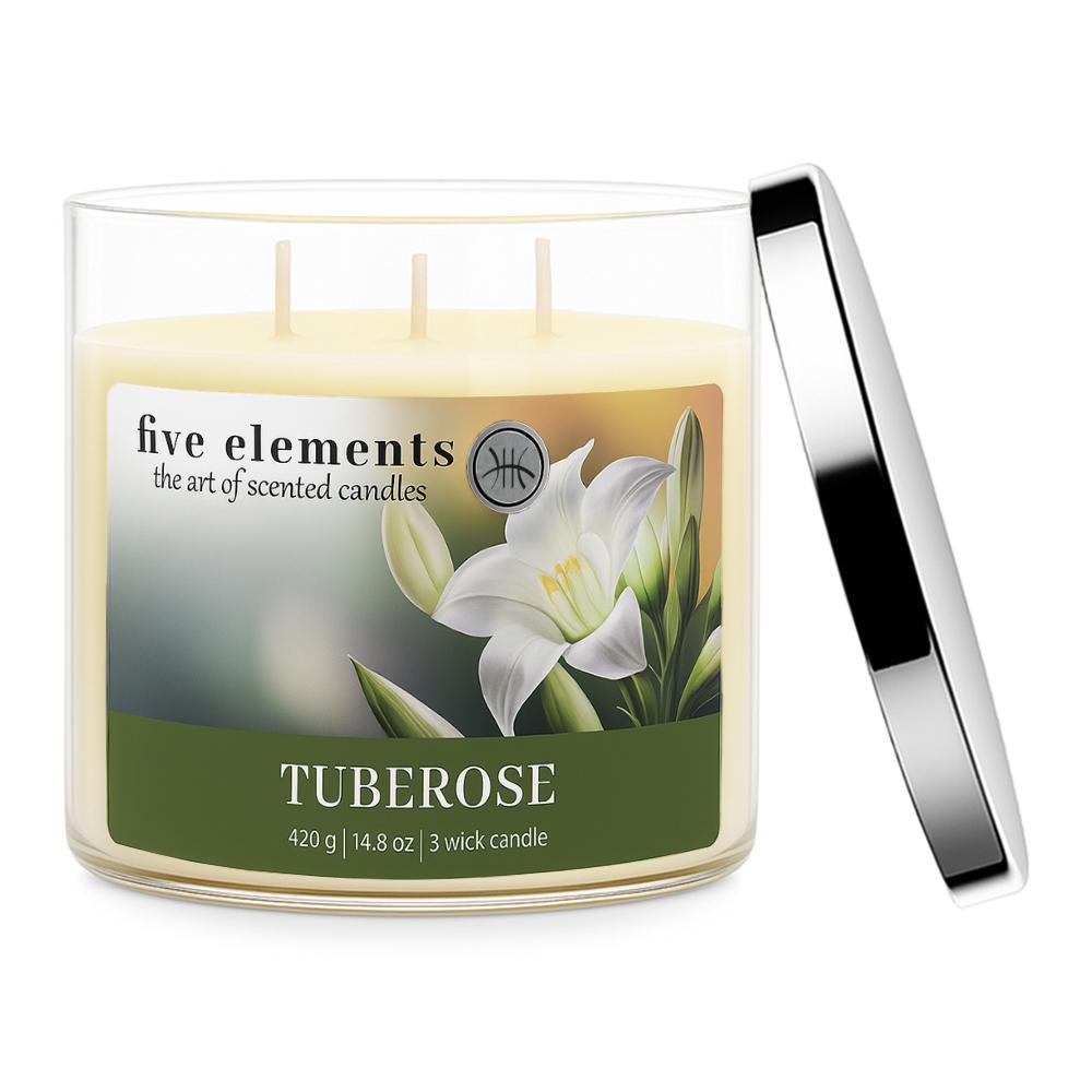 Eine Glas Kerze mit Tuberosenduft und drei Dochten. Silberner Deckel liegt daneben.