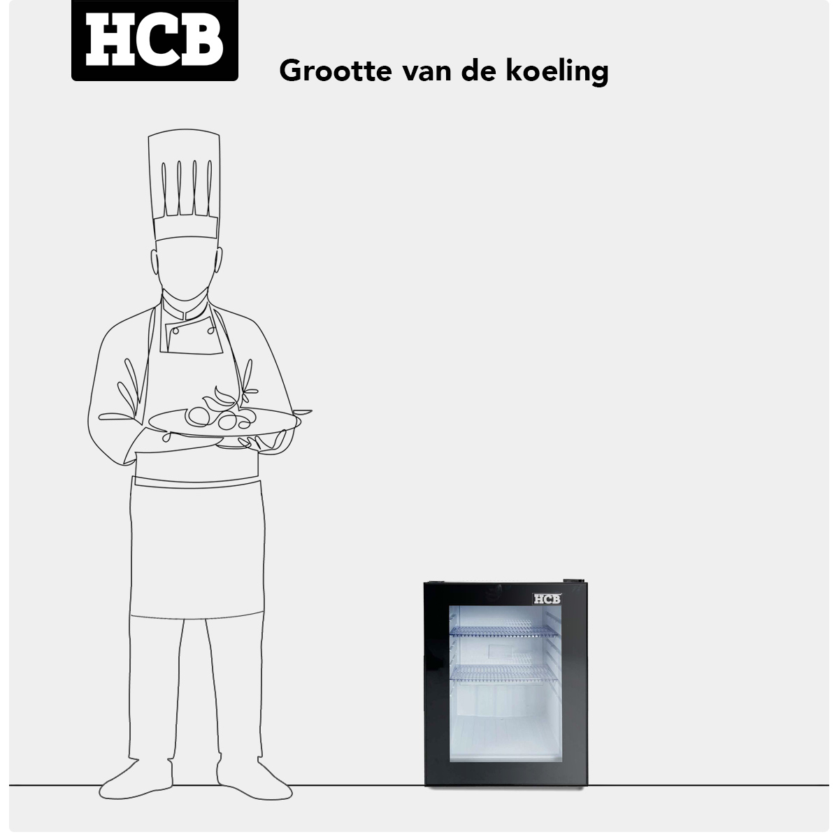 A chef in a toque holds a dish. A small refrigerator stands next to him.
