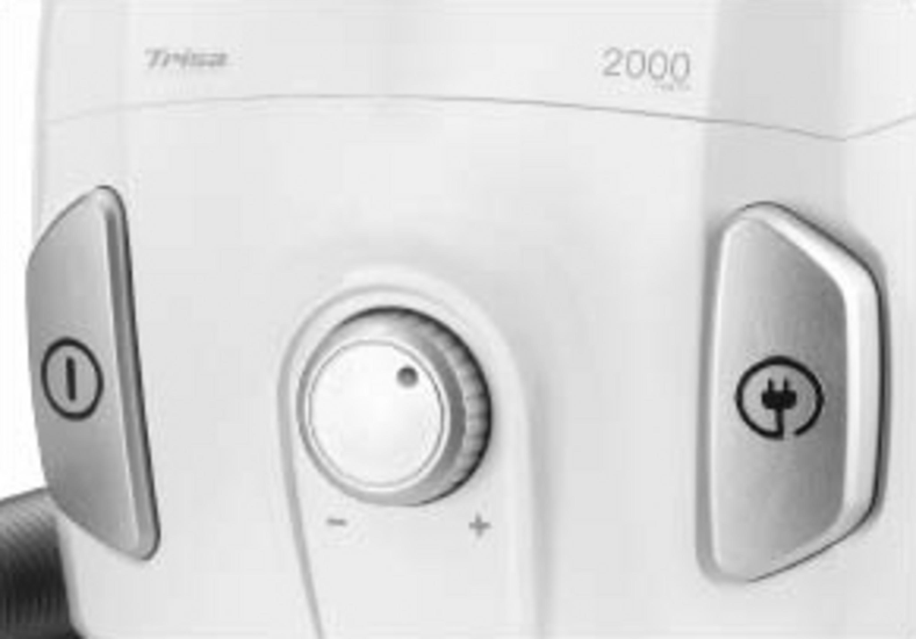 Gros plan d'un aspirateur blanc avec molette et symboles.