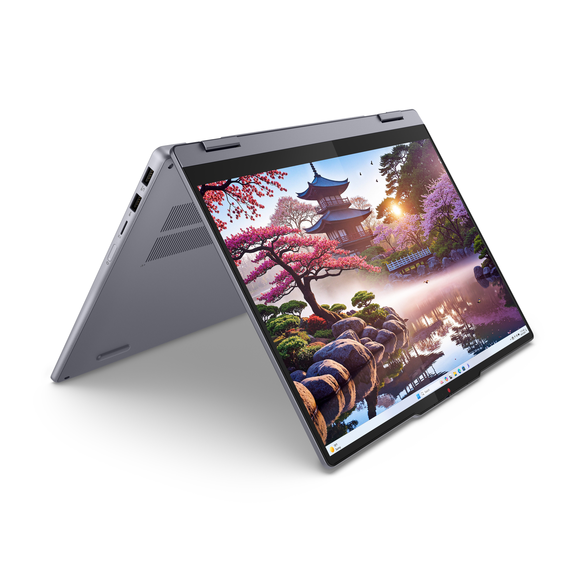 Otwarty laptop z japońskim ogrodem na ekranie o wschodzie słońca.