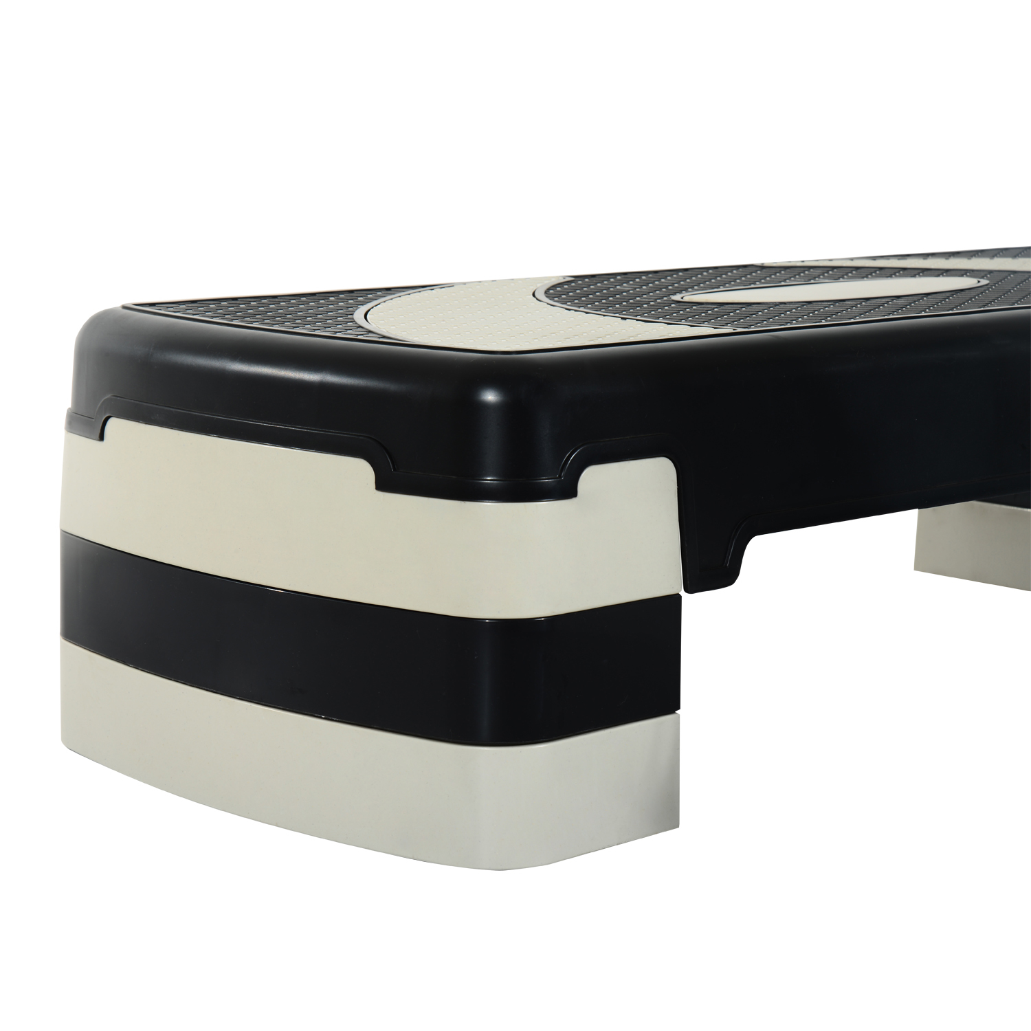 Peldaño de fitness negro y crema con superficie texturizada.