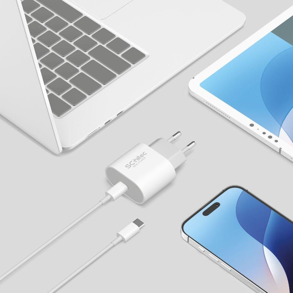 Laptop, tablet ve akıllı telefon yanında kablolu beyaz şarj adaptörü.