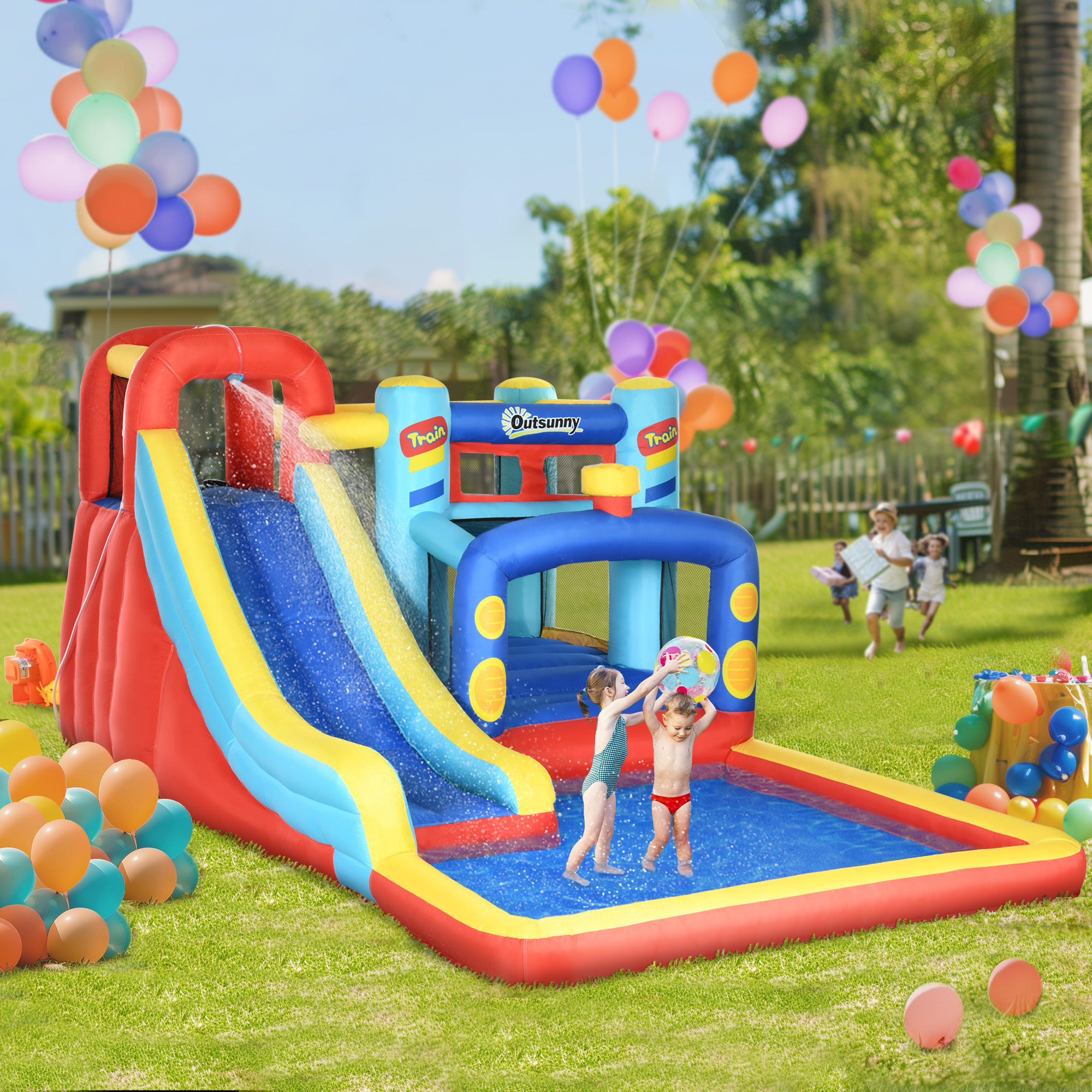 Tobogán acuático inflable con niños, pelota y globos coloridos en un patio.