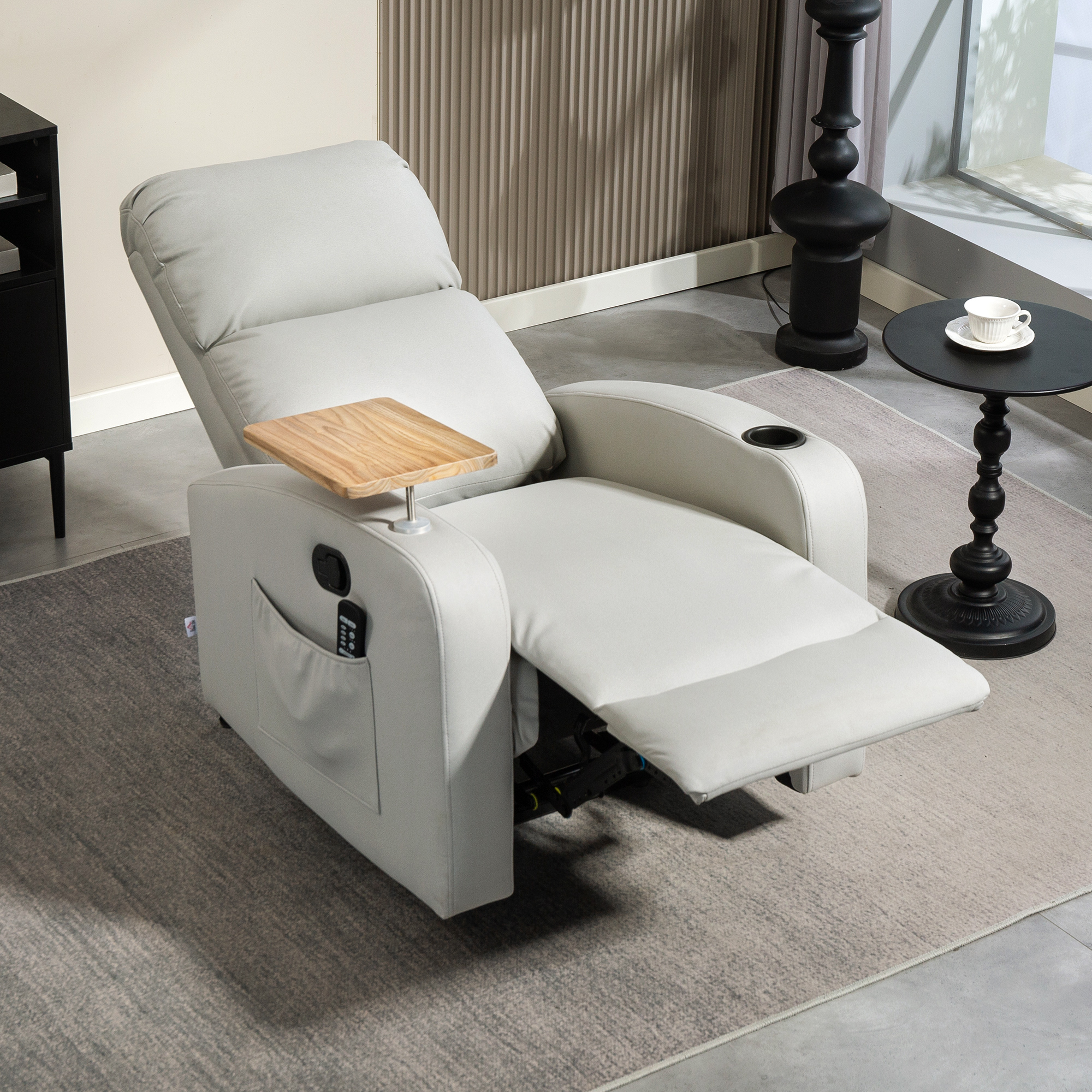 Un sillón reclinable claro con reposapiés extendido, portavasos y bandeja.
