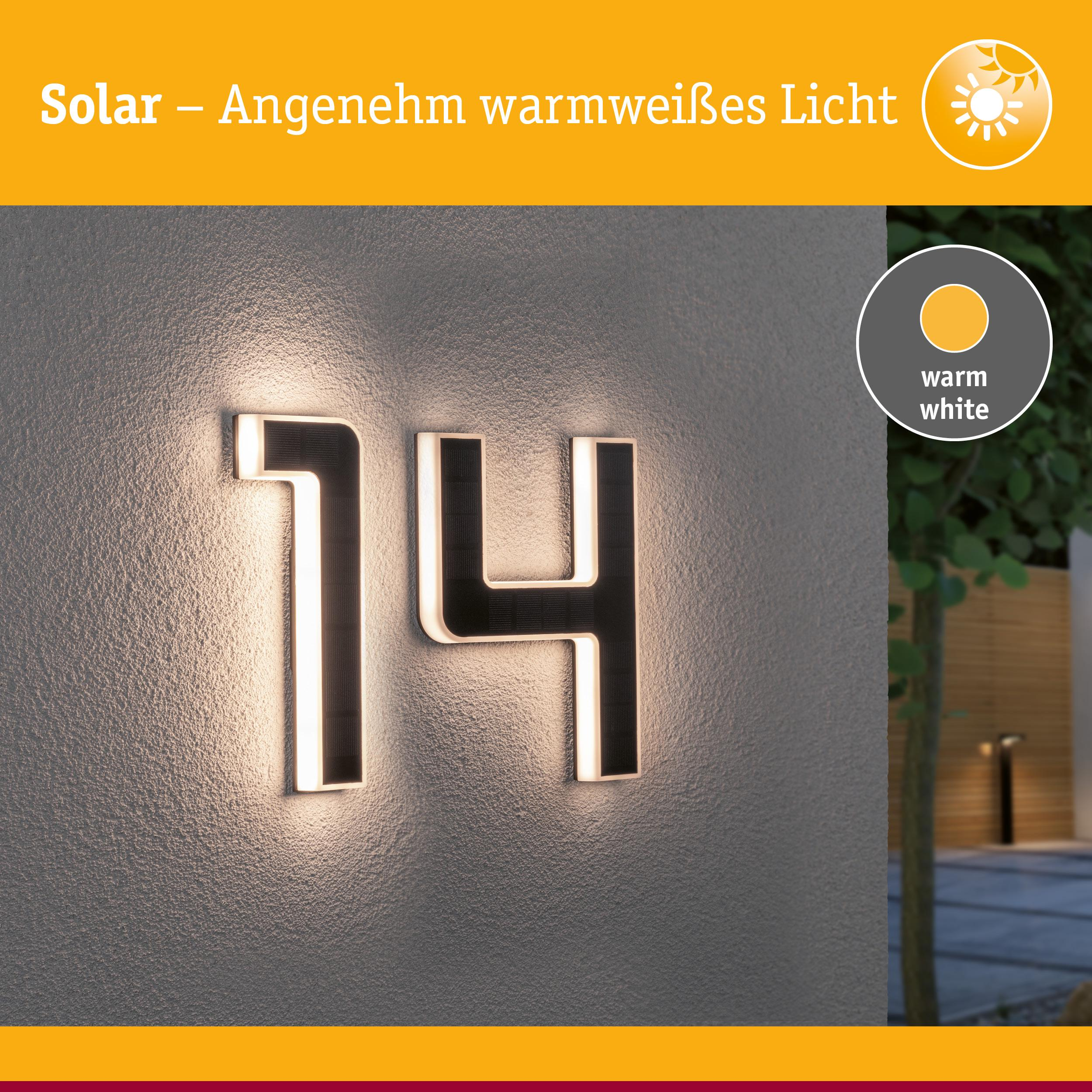 Numer domu 14 zasilany energią słoneczną, ciepłe białe światło na ścianie.