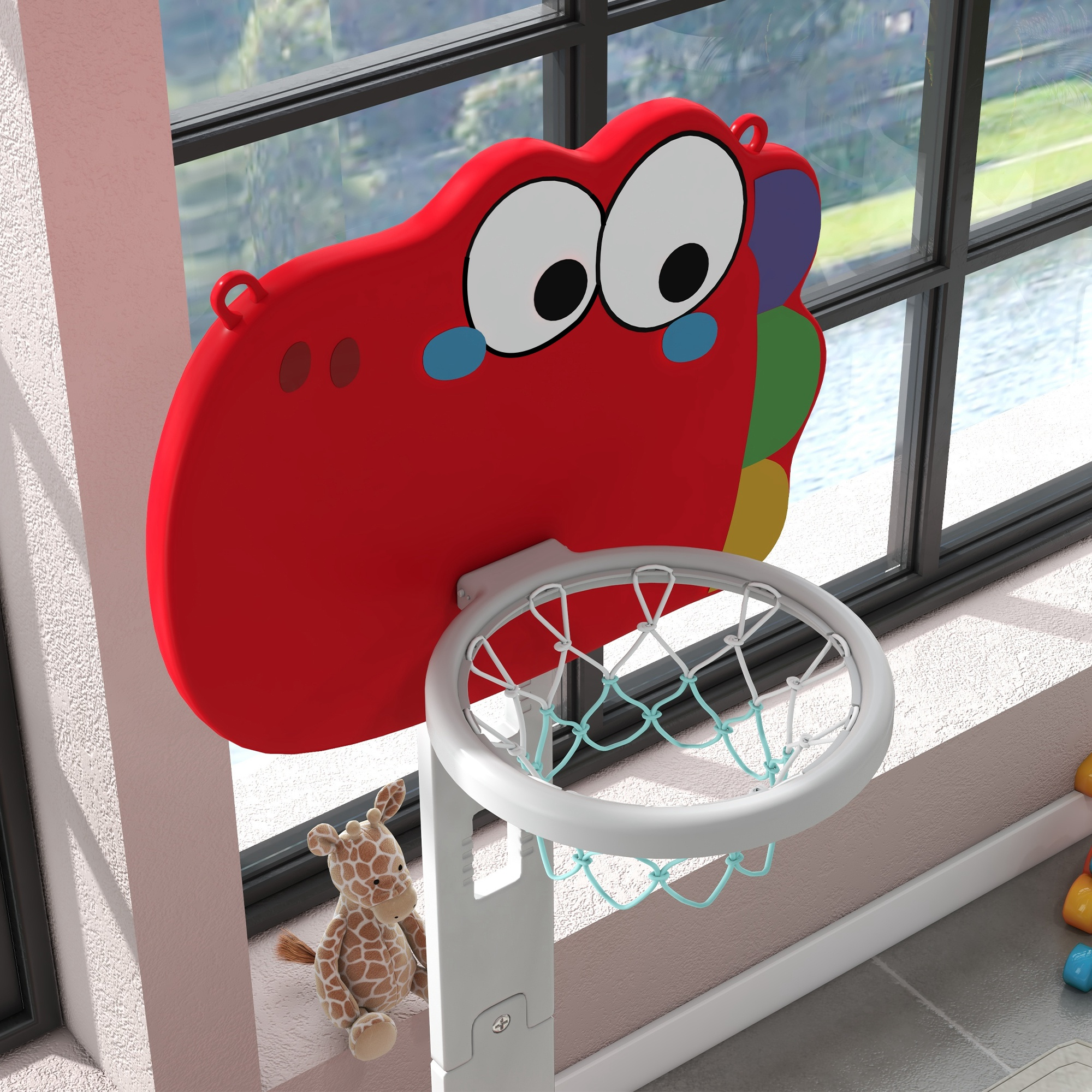 Una canasta de baloncesto roja con cara de dinosaurio y un peluche de jirafa al lado.