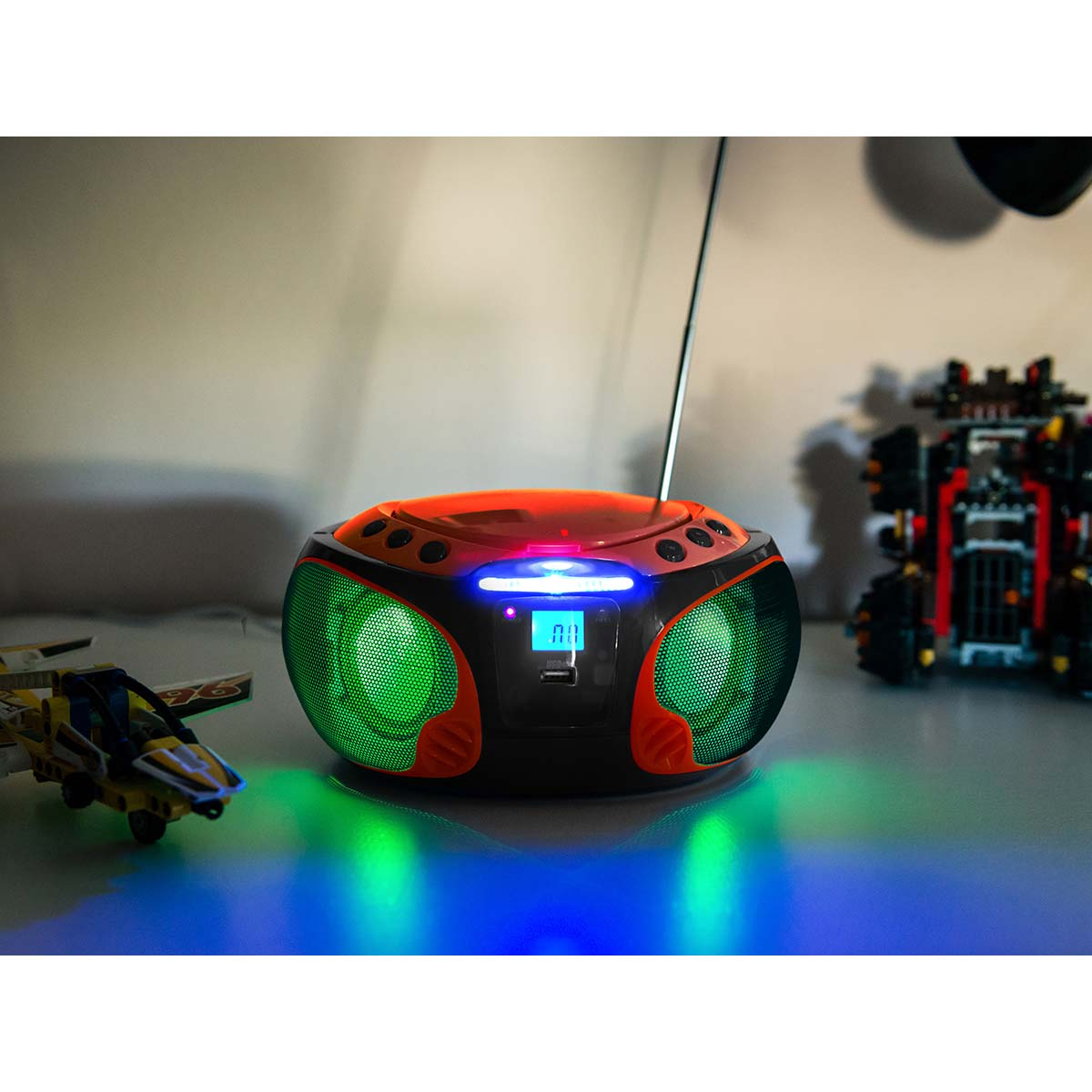 A portable boombox with green speakers and orange accents.