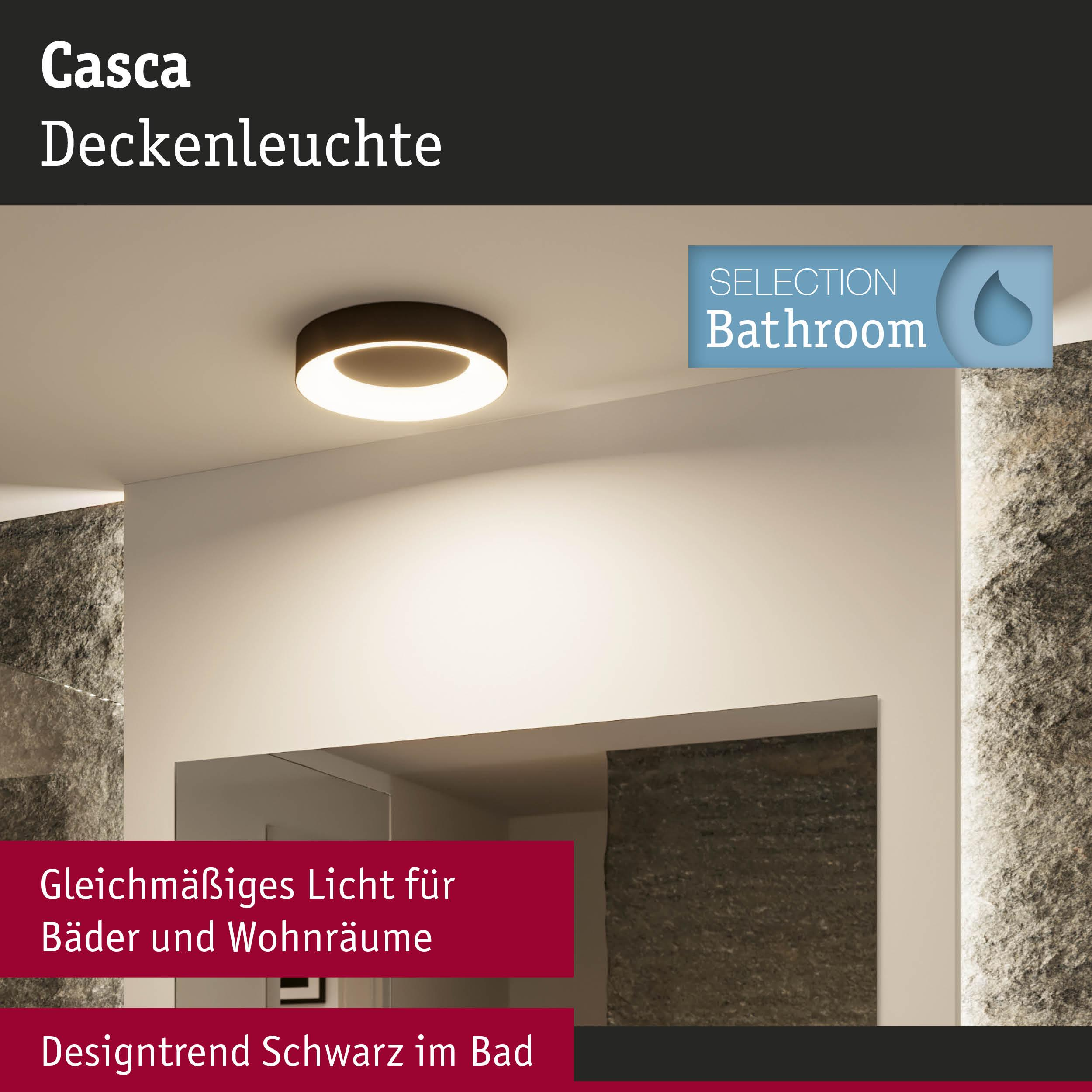 Moderne Deckenleuchte mit dunklem Rahmen und warmem Licht, daneben Steinwände.