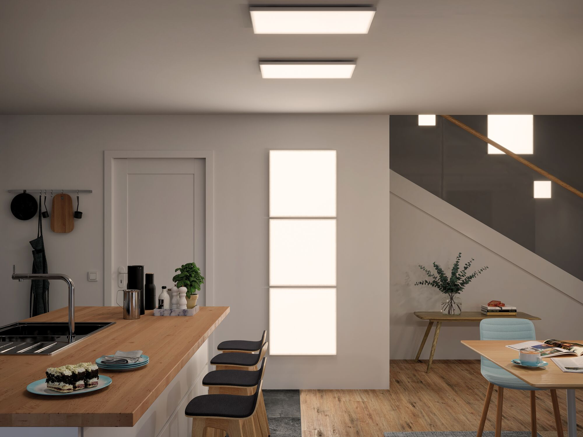 Moderne Küche mit Bar, Esstisch und Treppenhaus mit indirekter Beleuchtung.