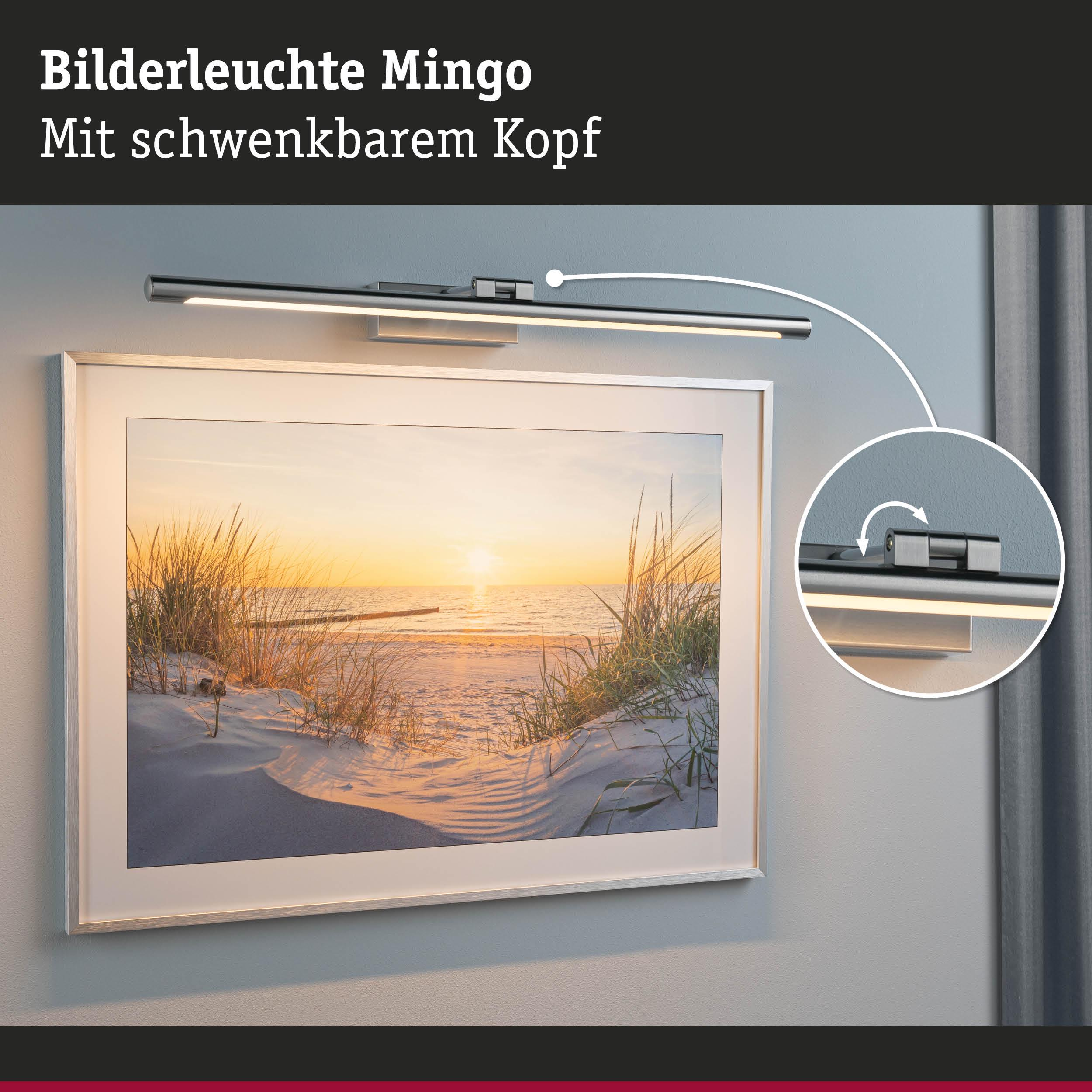 Lampa obrazowa nad oprawionym zdjęciem plaży o zachodzie słońca.