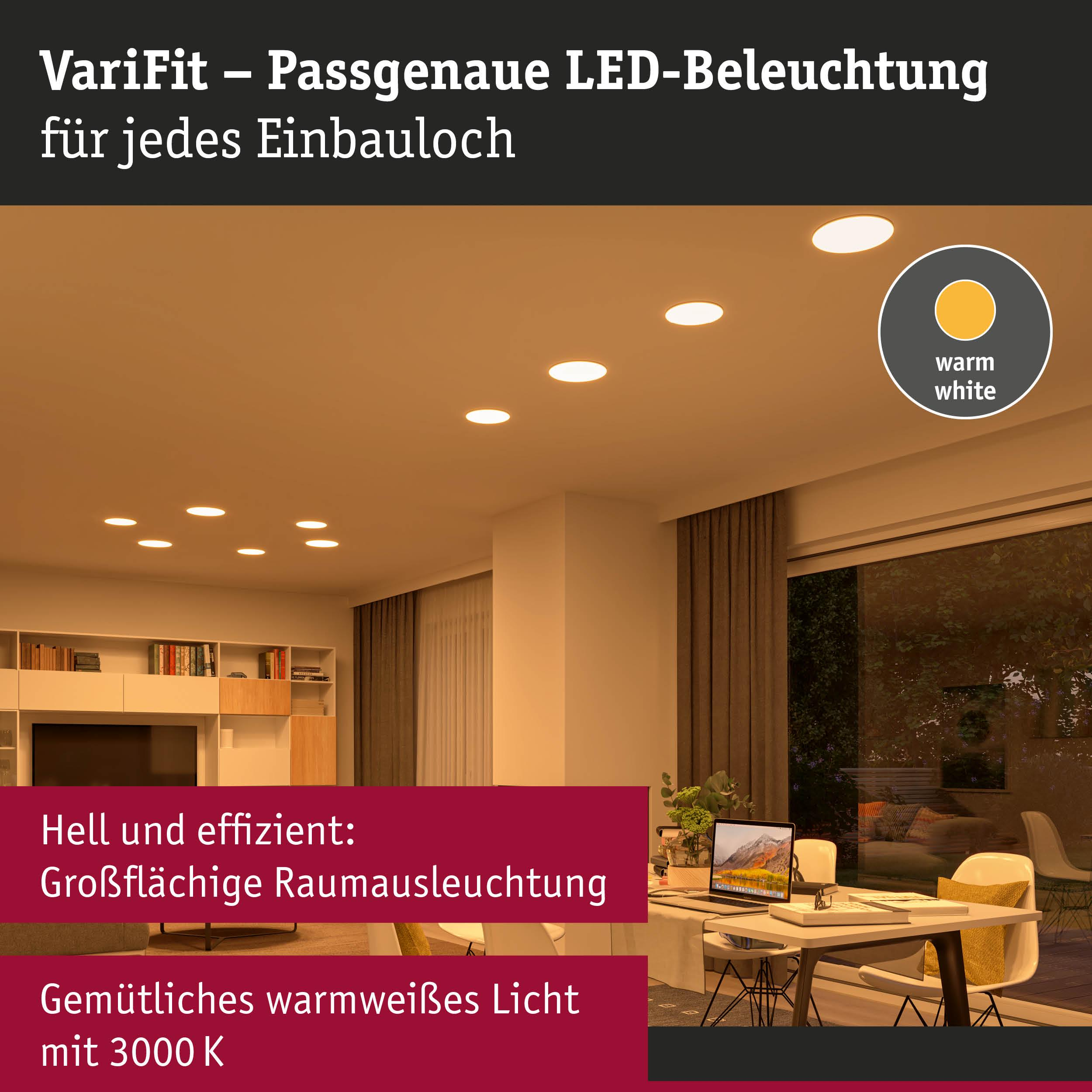 Ein Raum mit Einbauspots und einem Tisch mit Laptop und Kissen.