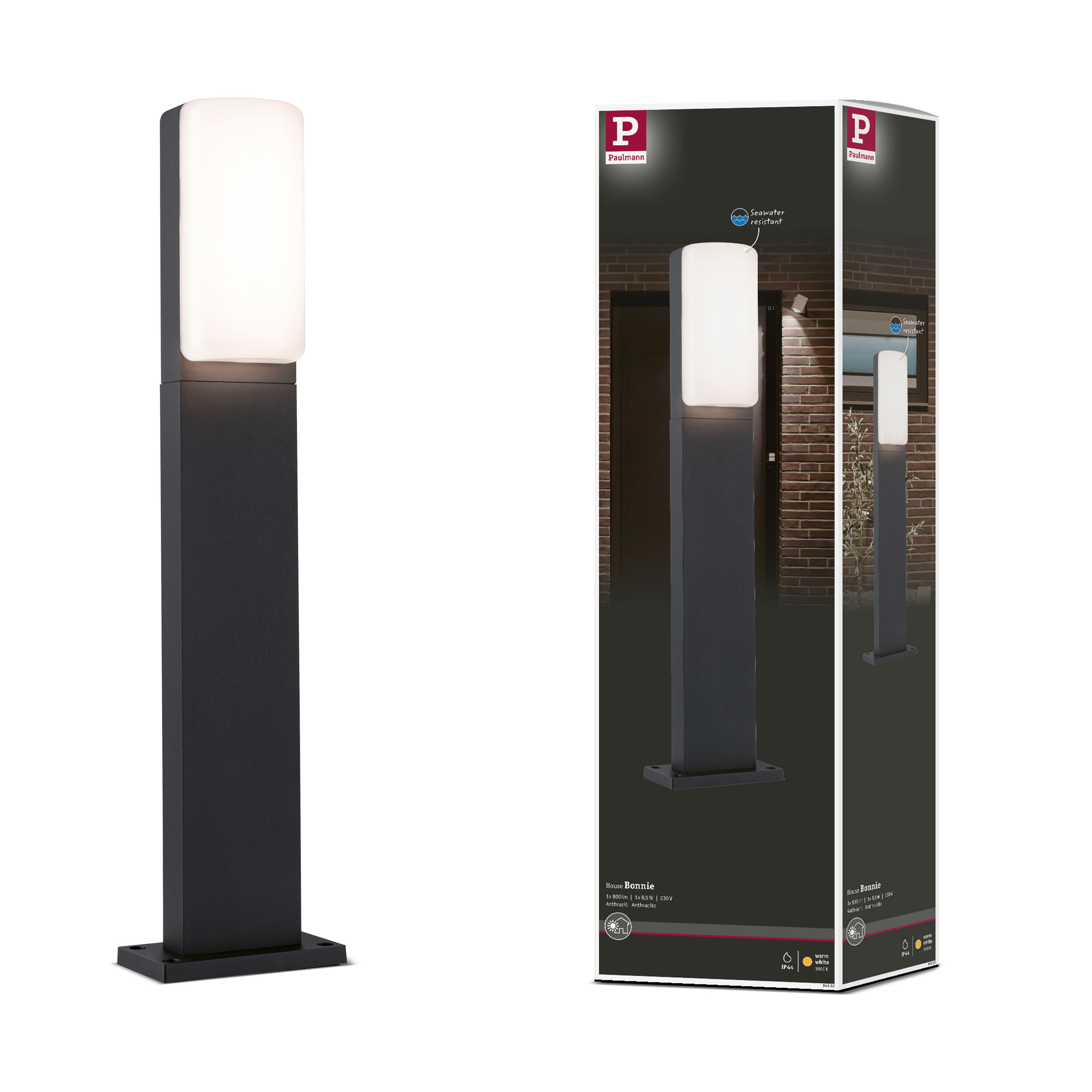 Ciemna lampa zewnętrzna z prostokątną, białą, świecącą głowicą na cokole.