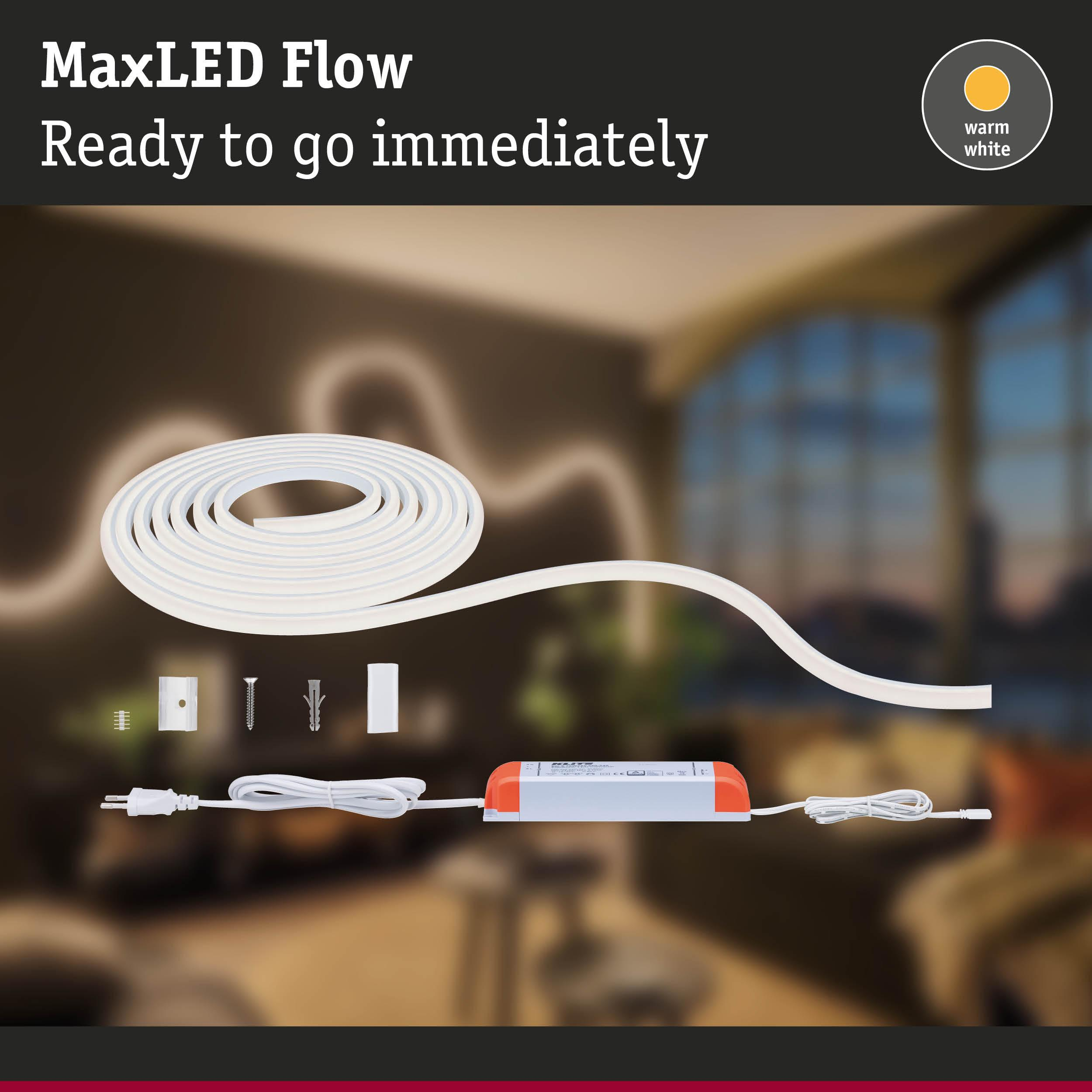 Un bandeau LED flexible blanc avec alimentation et fixations sur une table.