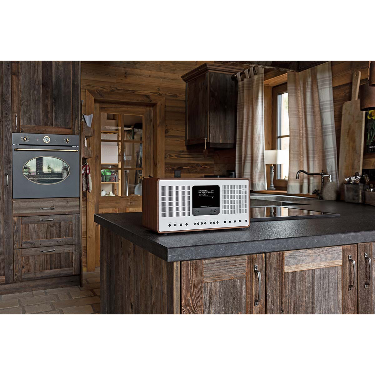 Wooden kitchen with a retro radio on the counter and an oven.