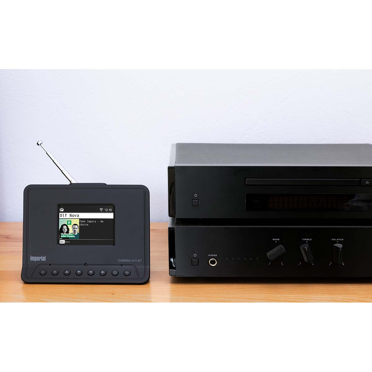 A black DAB radio and CD player sit on a wooden table.