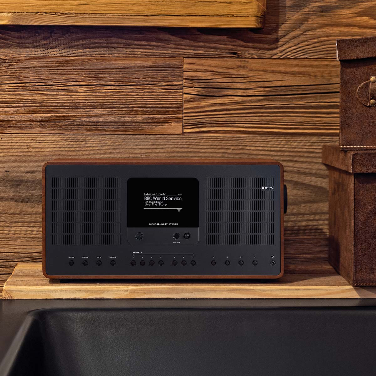 A wooden radio with a black display plays BBC World Service.