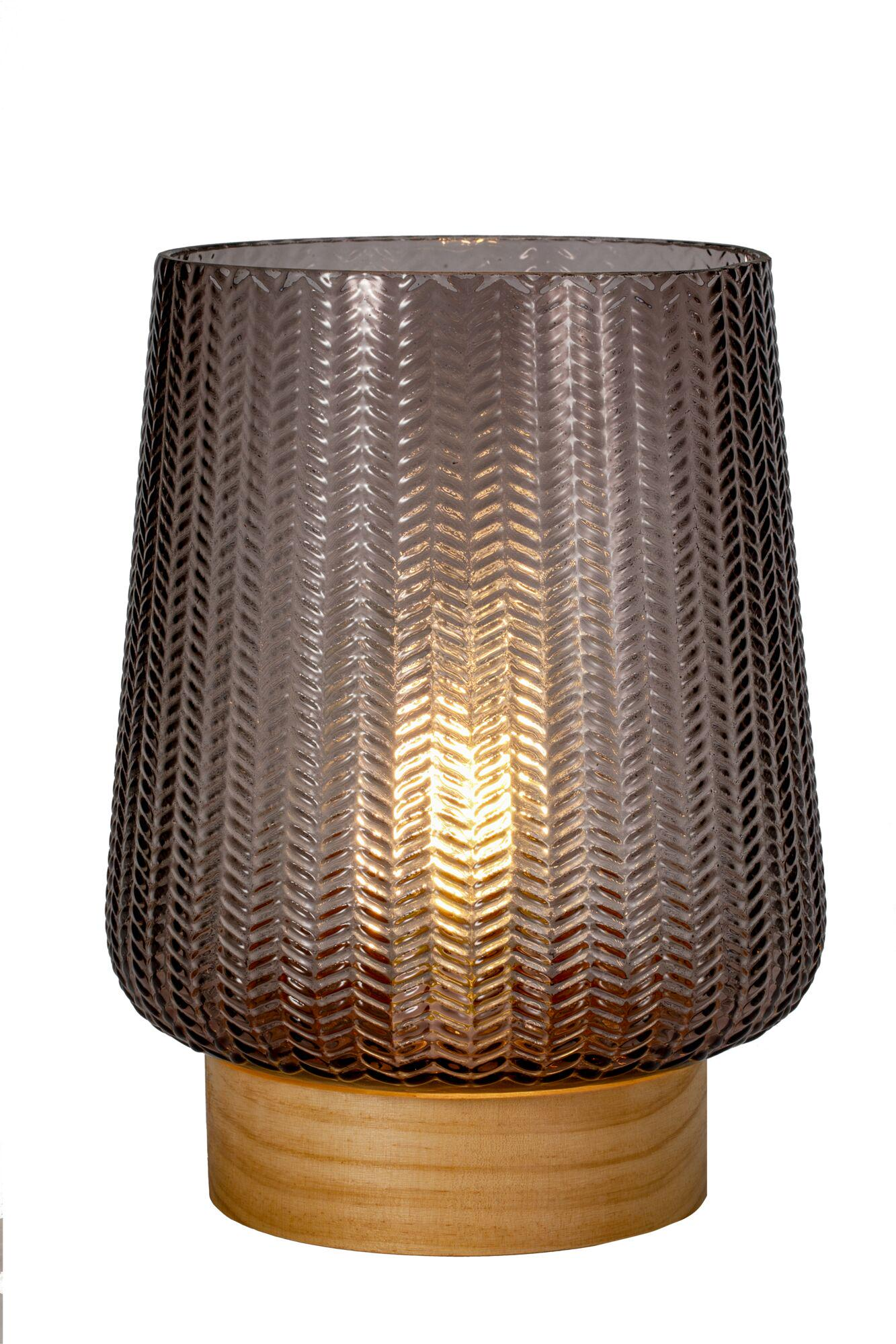 Szara szklana latarnia ze wzorem zygzak na drewnianej podstawie.