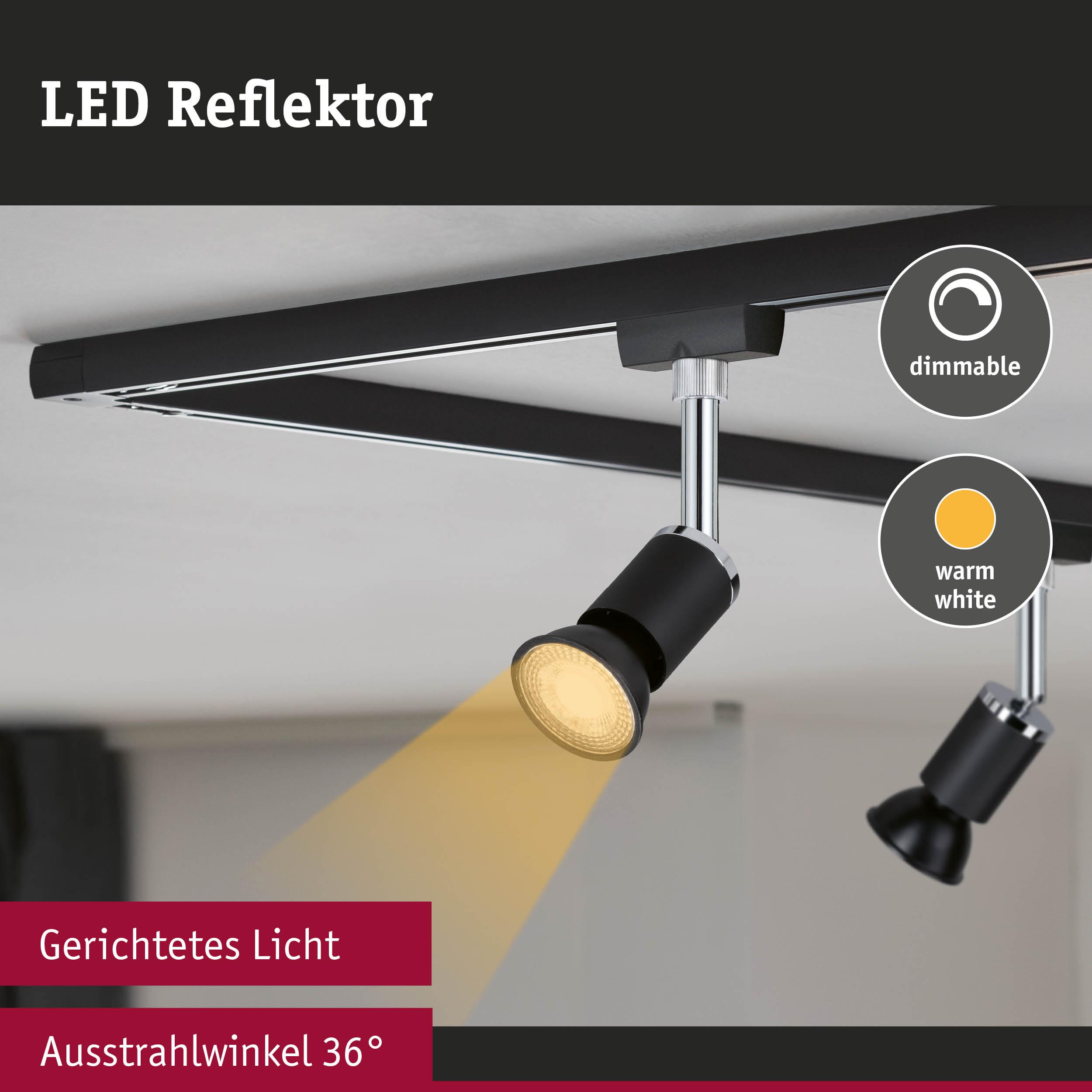 Dwa czarne reflektory LED na szynie, jeden emituje ciepłe białe światło.