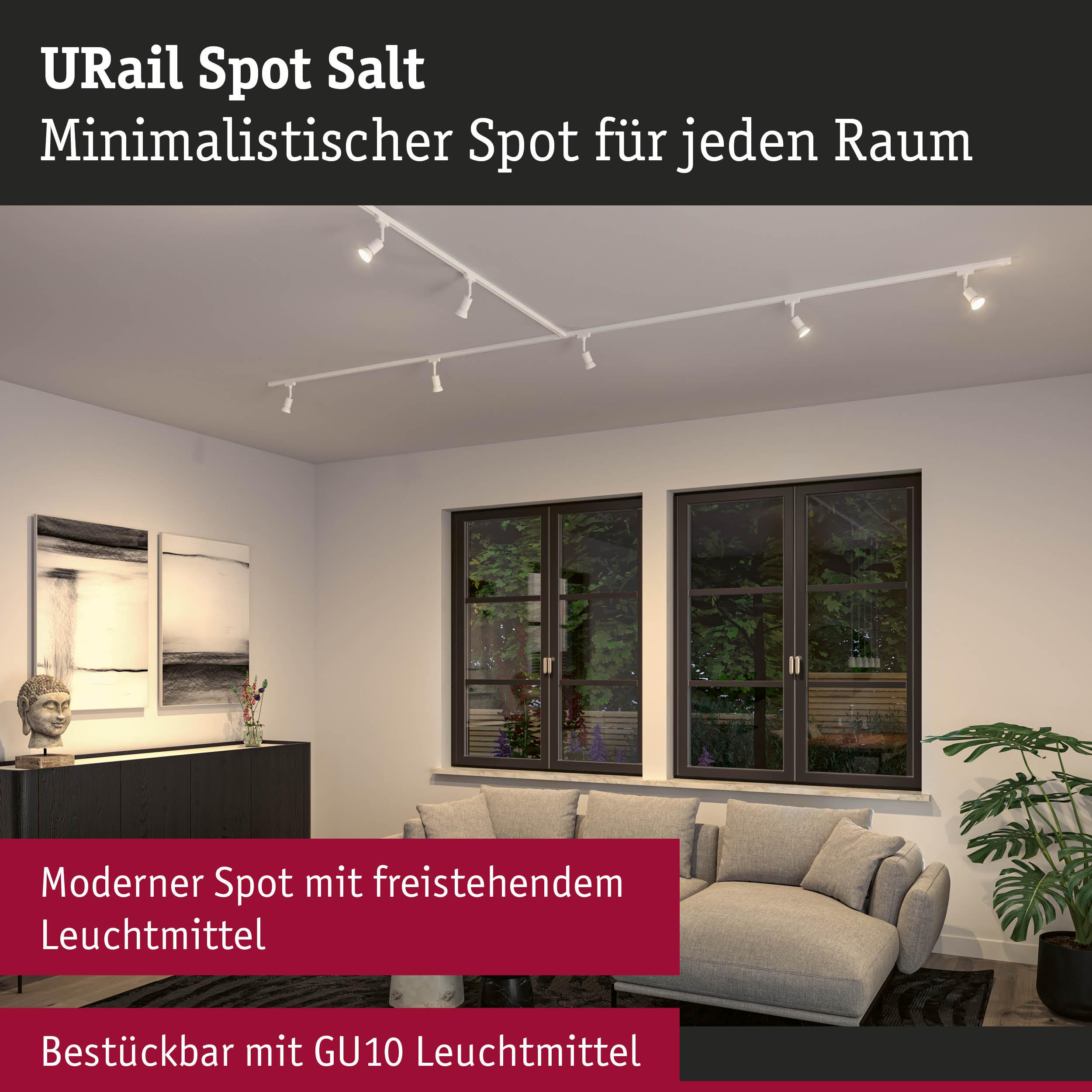 Modern eingerichtetes Wohnzimmer mit Schienenspots an der Decke und Sitzmöbeln.