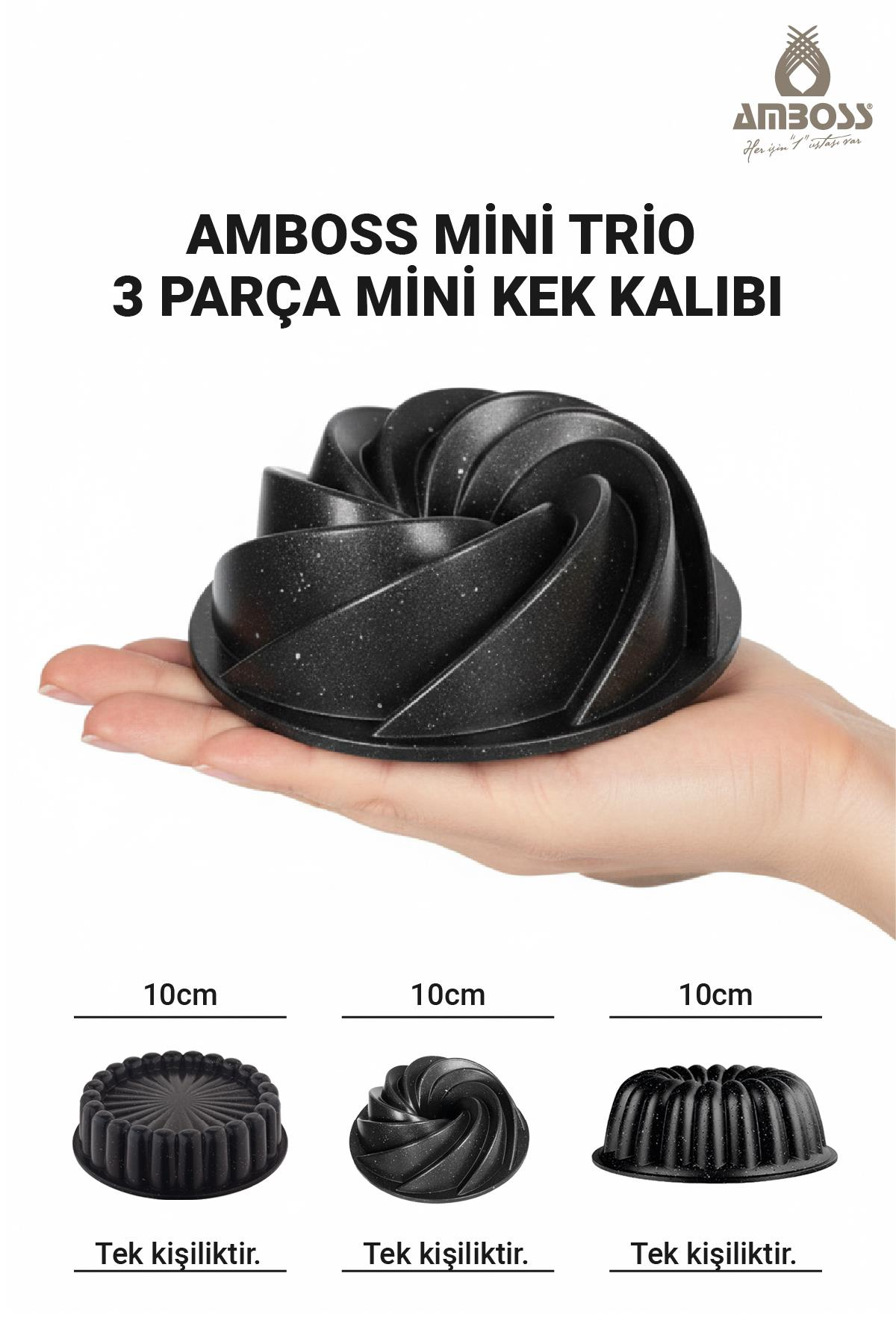 Elde tutulan siyah spiral kek kalıbı, yanında üç adet 10cm'lik kalıp.