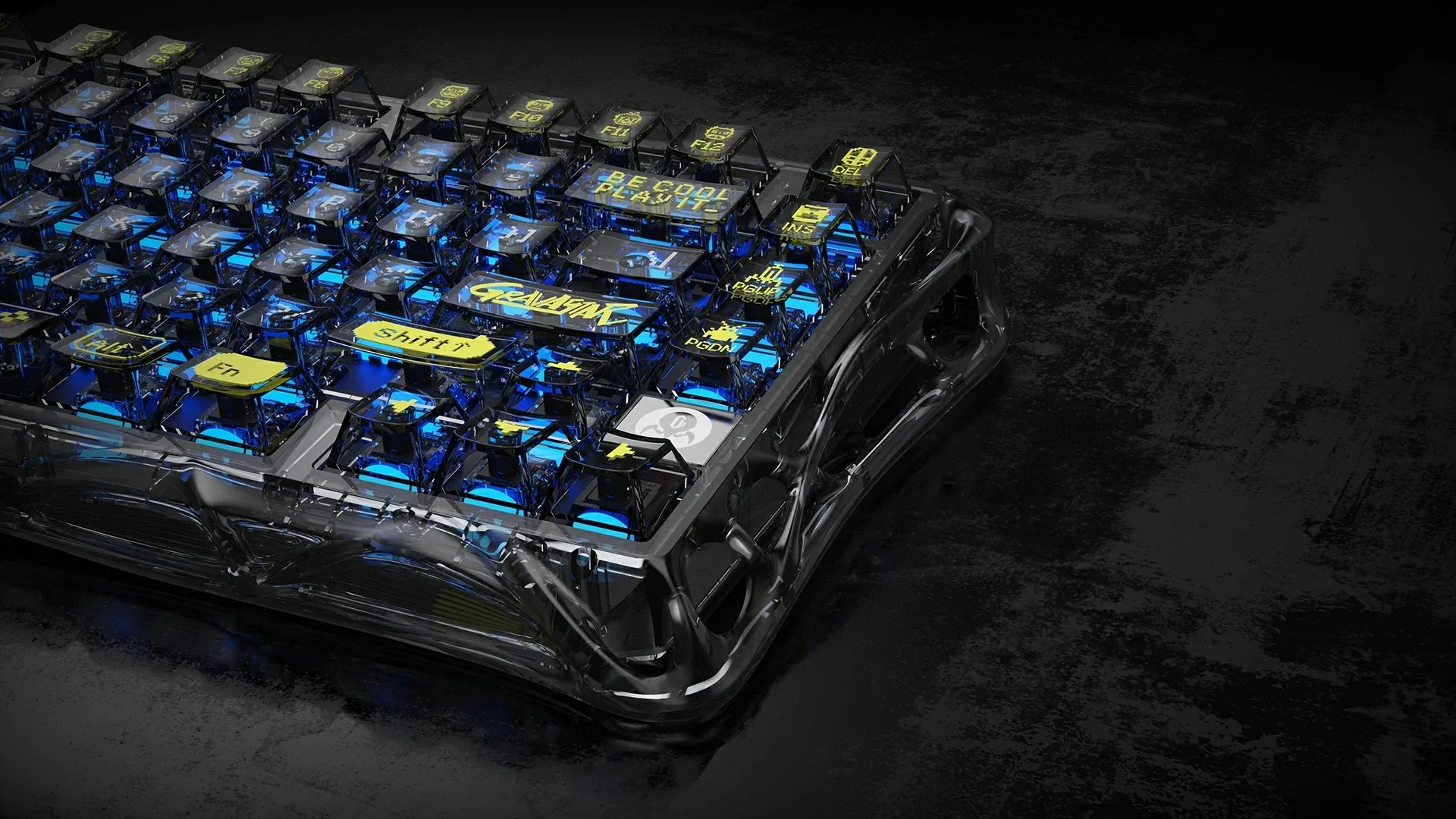 Przezroczysta klawiatura z niebieskim podświetleniem i żółtymi klawiszami na ciemnej powierzchni.