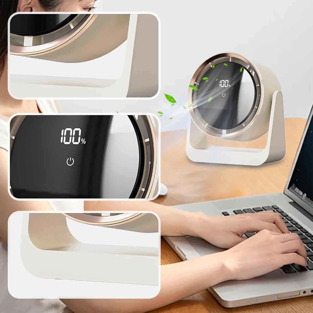 Ein kleiner Ventilator mit 100% Anzeige neben einer Person, die tippt.