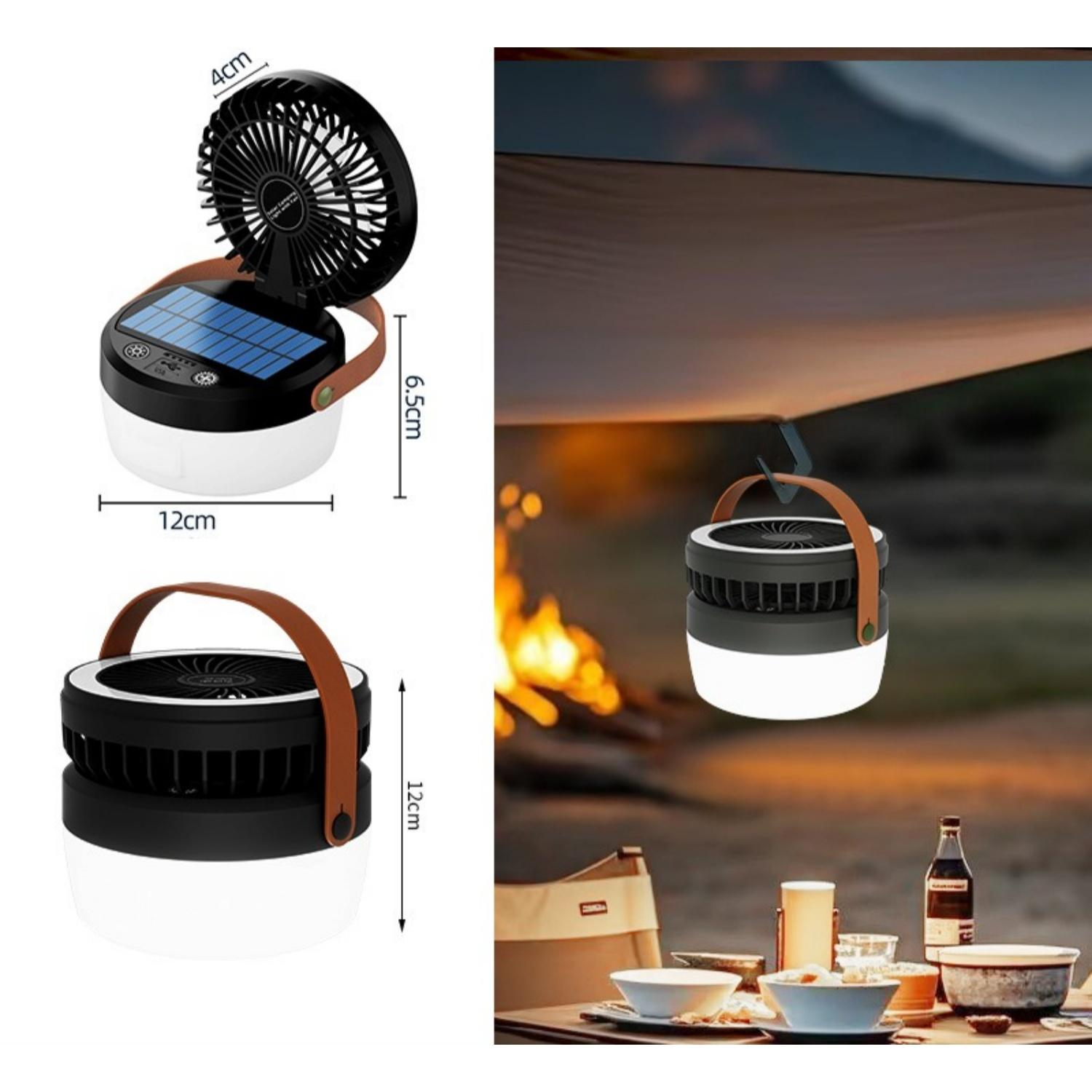 Ein Campingventilator mit Solarpanel und LED-Licht hängt über einem Tisch.