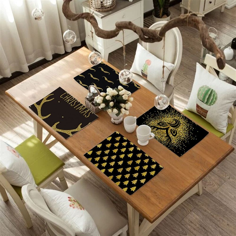 Ein Holztisch für Weihnachten gedeckt mit Platzsets mit Geweihen und Bäumen.
