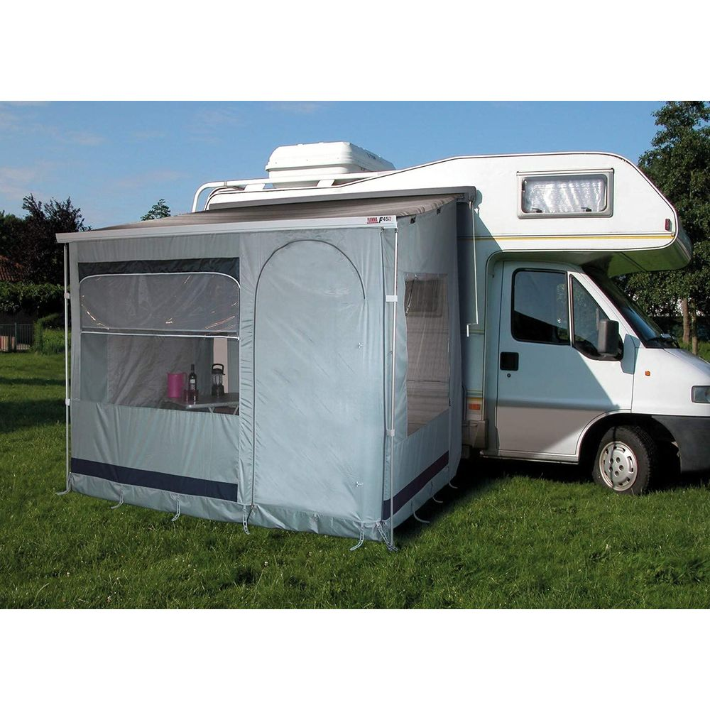 Wohnmobil mit Vorzelt auf einer grünen Wiese.
