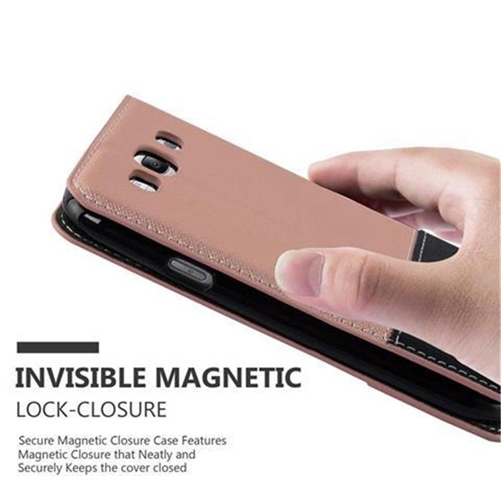 Una mano tiene una custodia per telefono rosa con chiusura magnetica.
