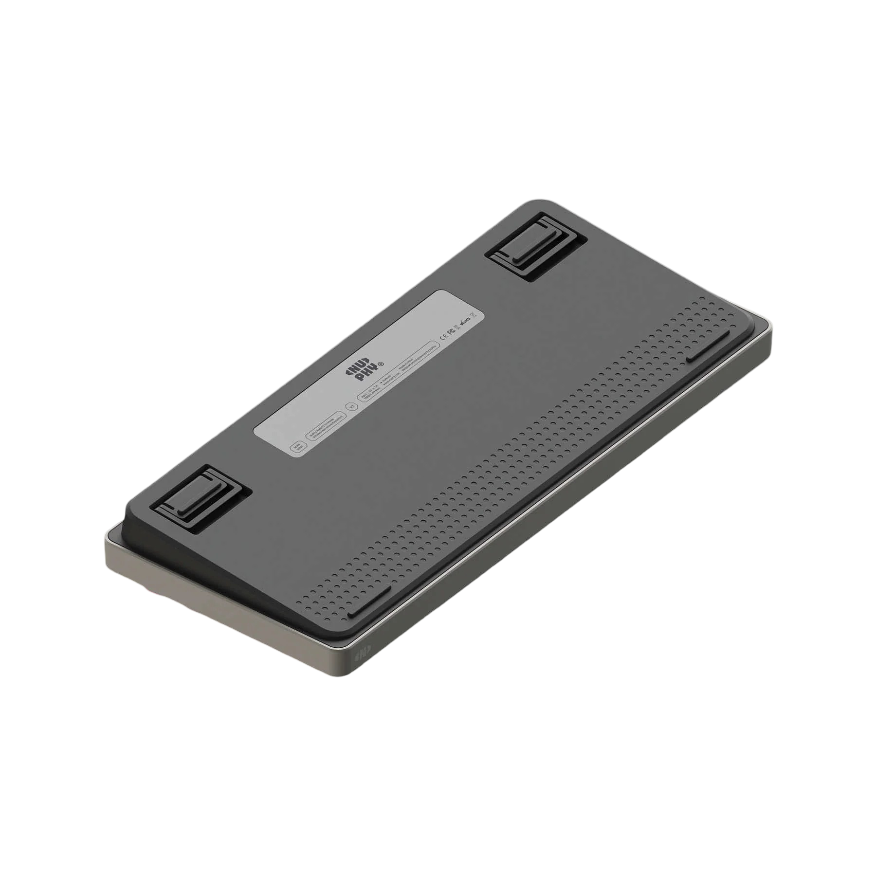 Spód ciemnej klawiatury z srebrną ramką i gumowymi nóżkami.