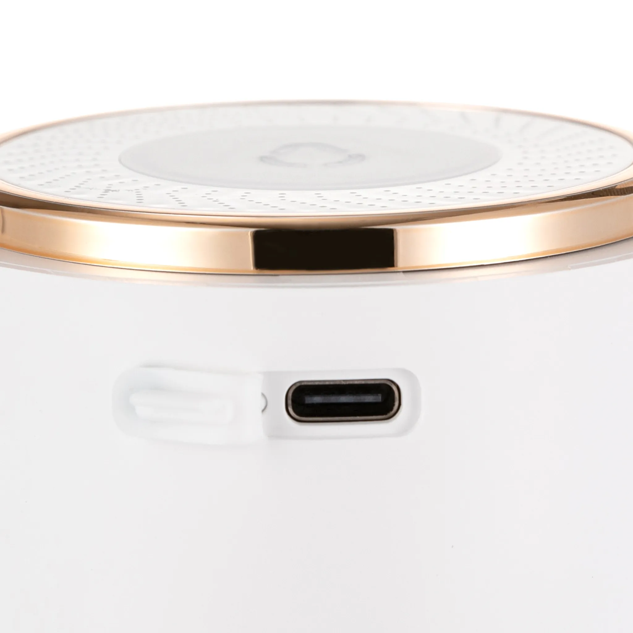 Ein weißes Gerät mit USB-C-Anschluss und goldener Lünette.