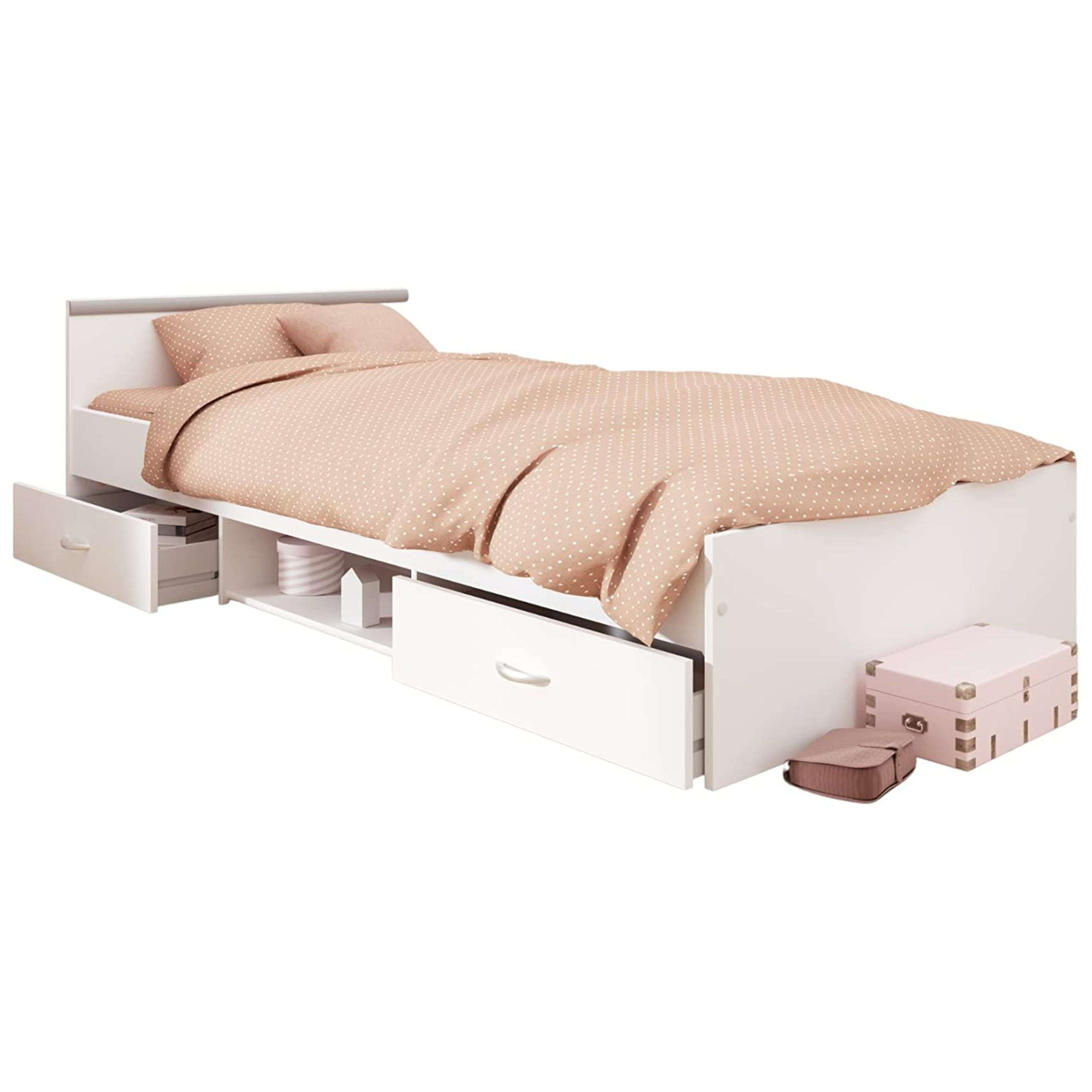 Una cama blanca con ropa de cama de lunares rosas y cajones integrados.