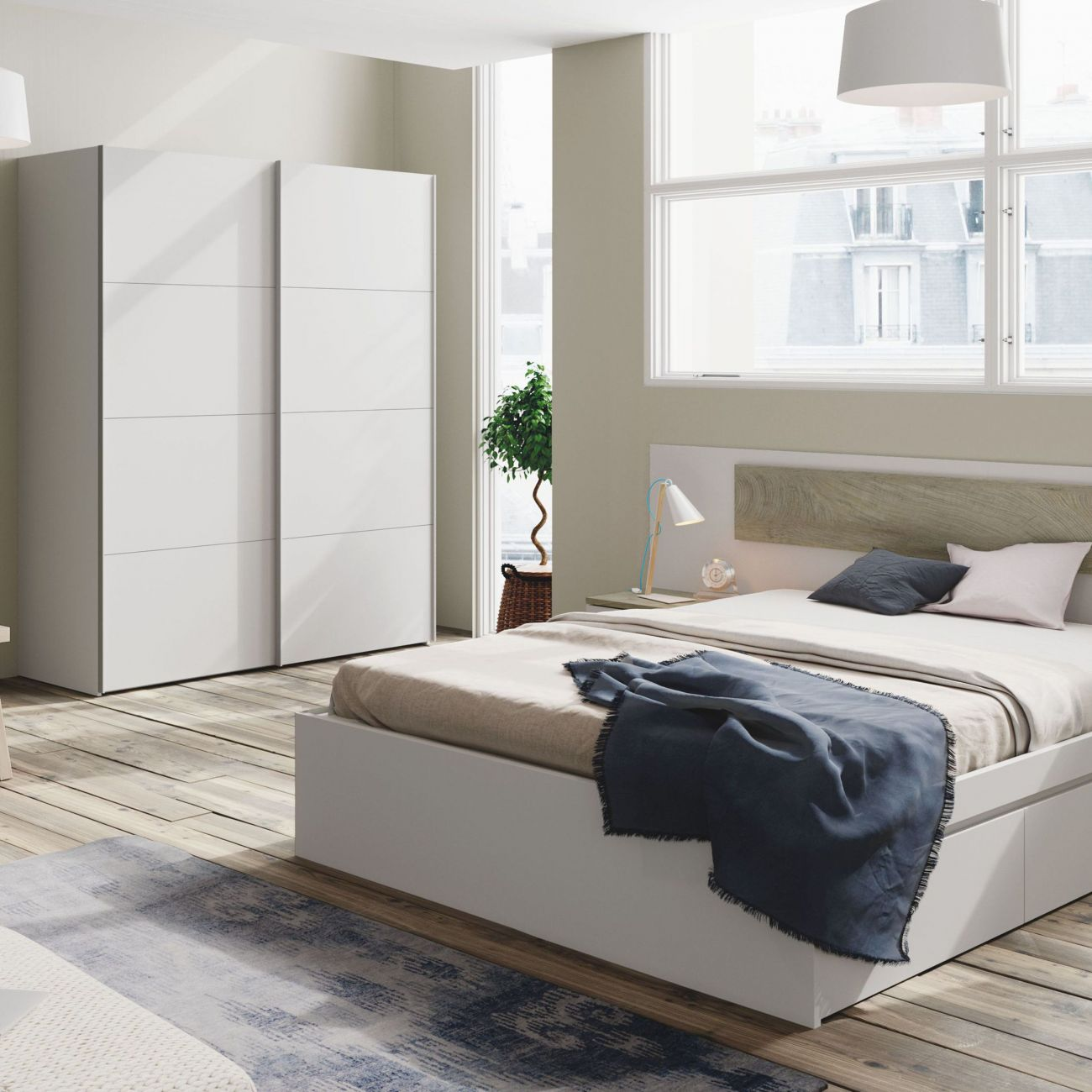 Dormitorio moderno con armario blanco, cama con manta azul y ventana grande.