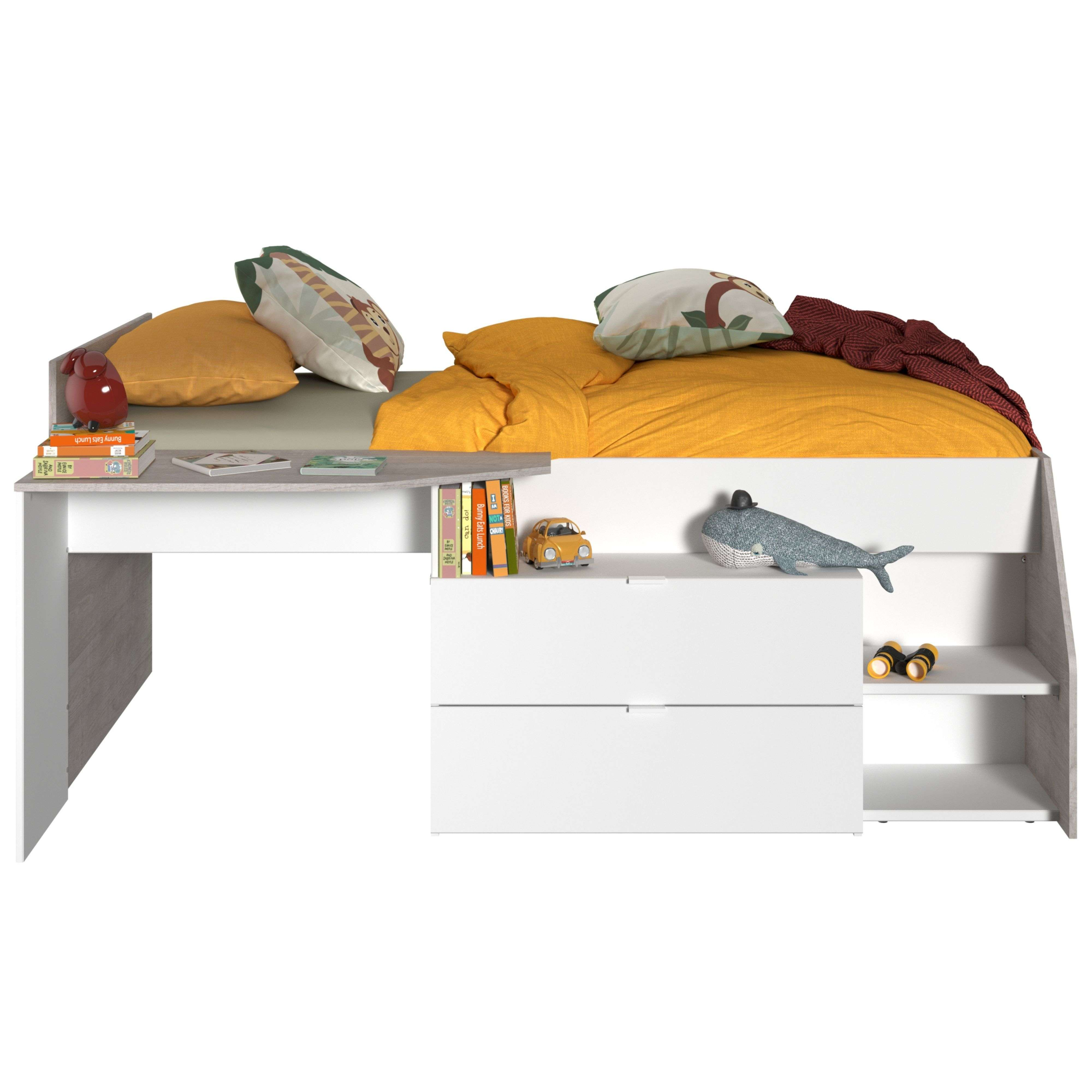 Una cama infantil con escritorio, con ropa de cama amarilla, cojines, libros y juguetes.