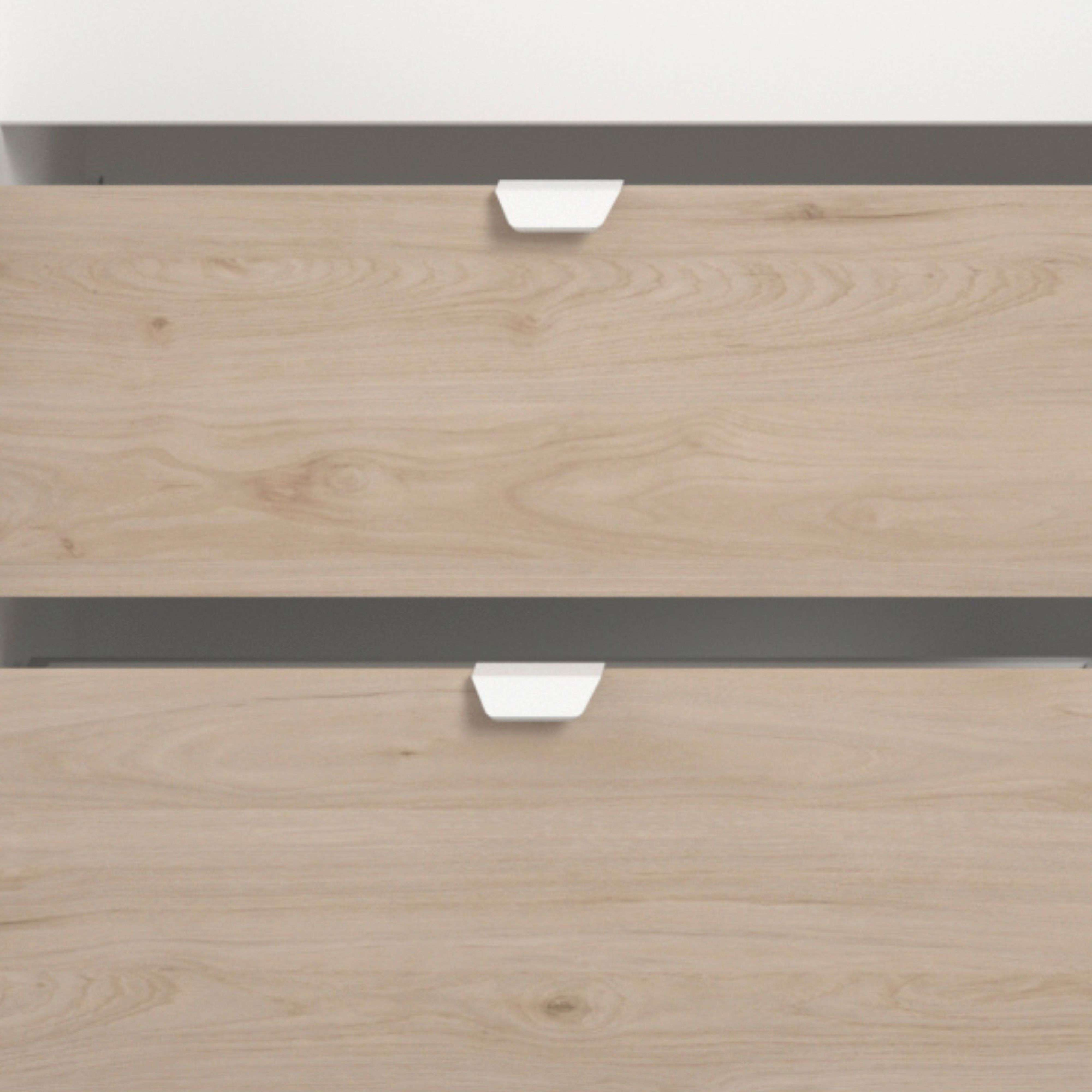 Dos cajones con veta de madera clara y tiradores blancos sobre fondo blanco.