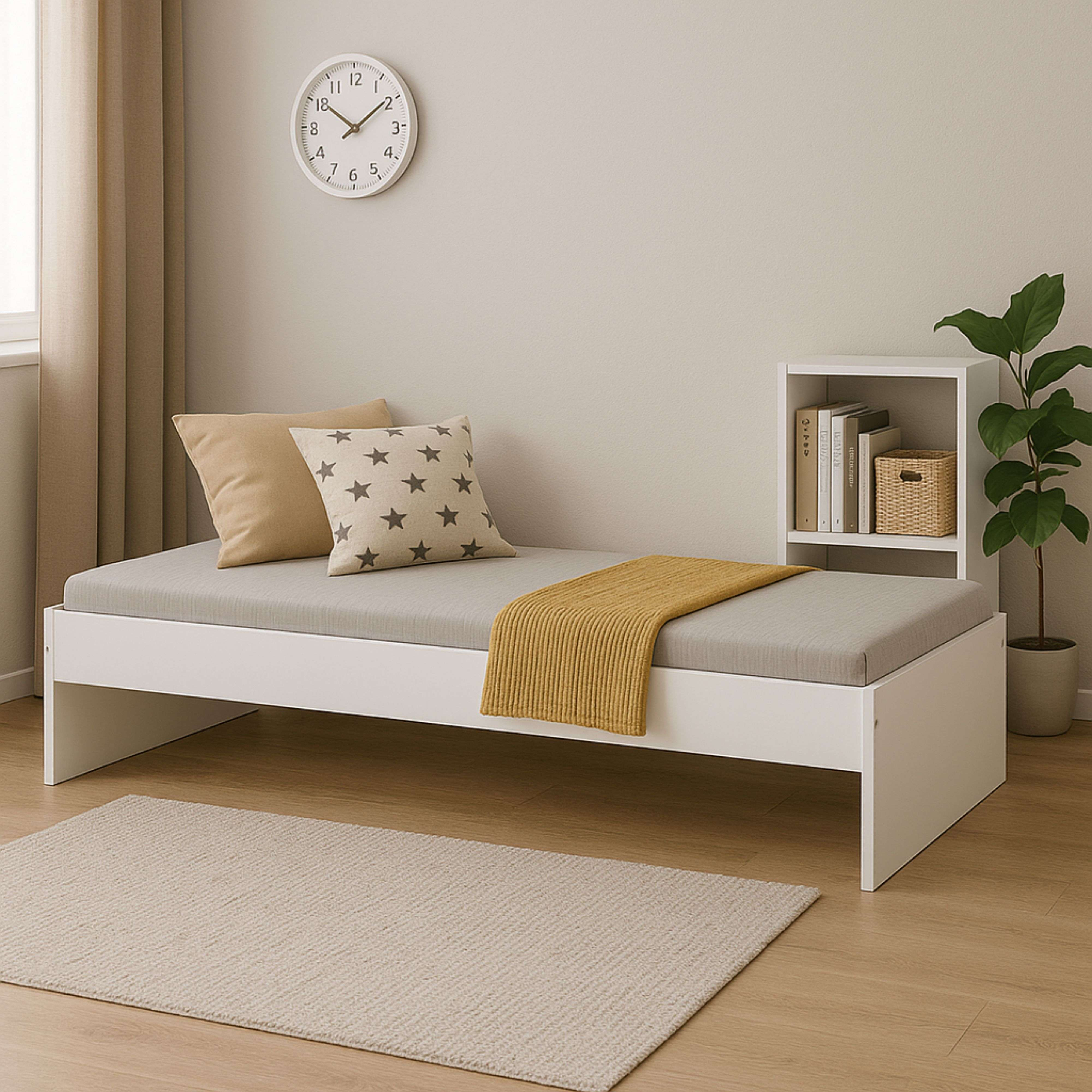 Una cama blanca con colchón gris, almohadas, manta amarilla, reloj y estante.