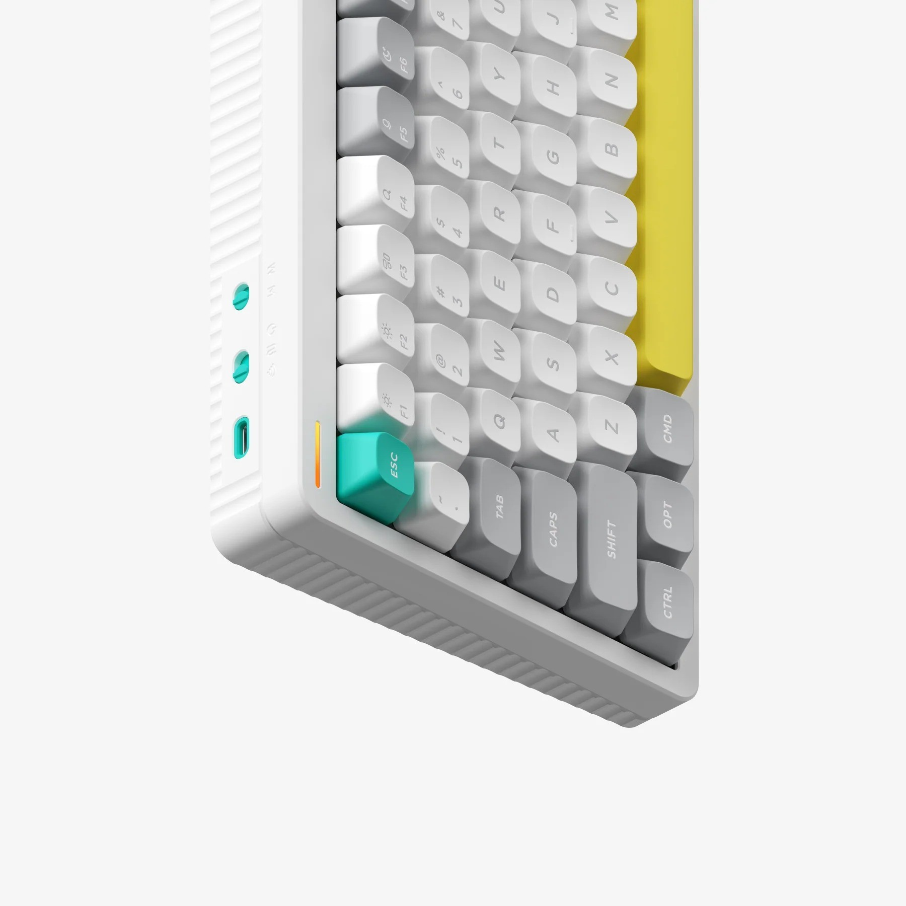Biała klawiatura mechaniczna z szarymi i turkusowymi klawiszami. Widoczny jest żółty klawisz akcentujący.